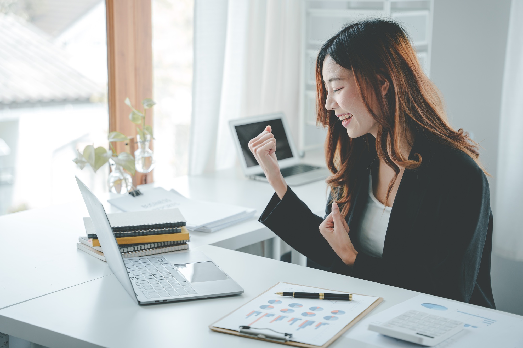 Young businesswoman excited about achieving sales goals