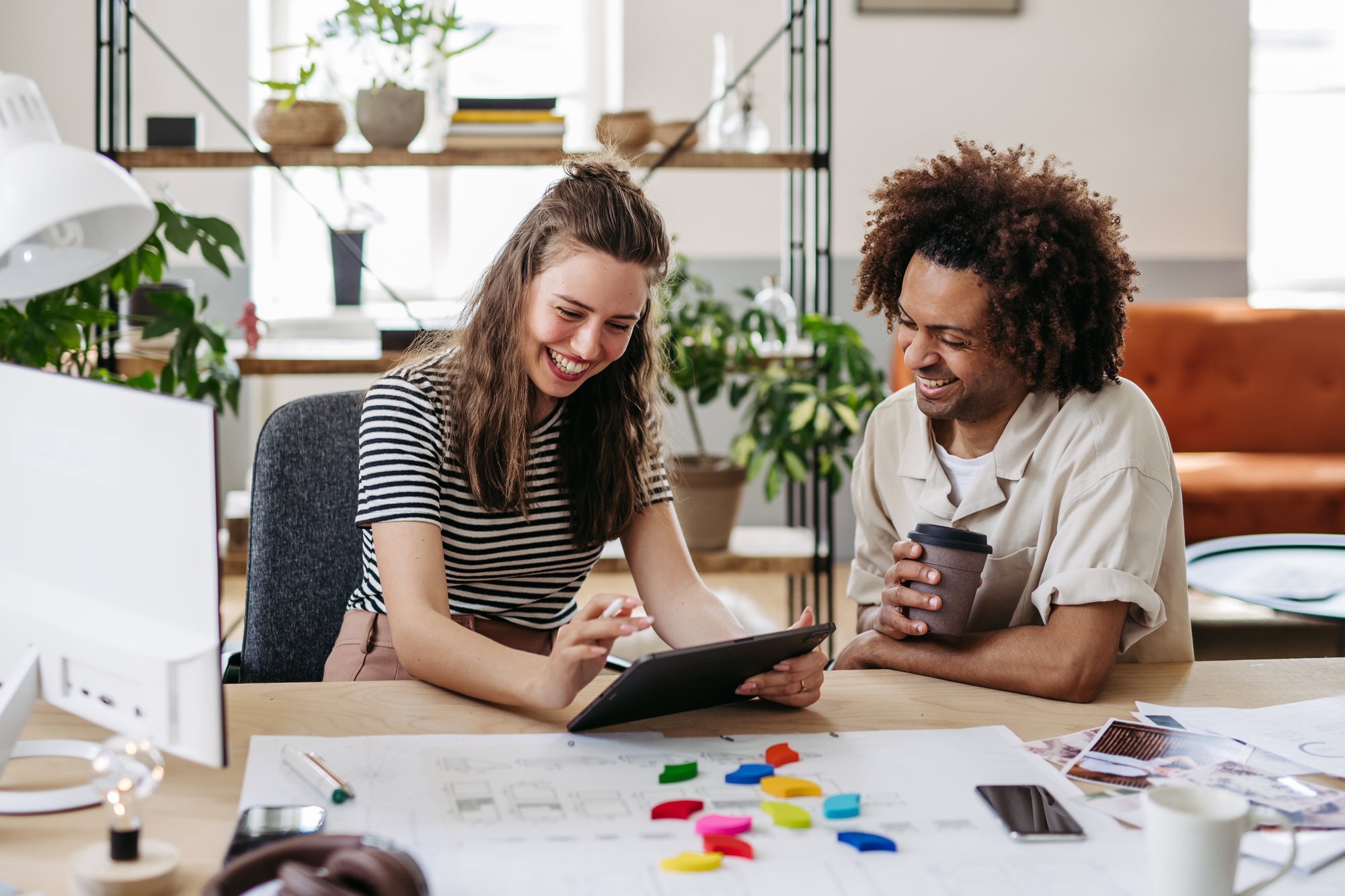Young colleagues working together in startup company.