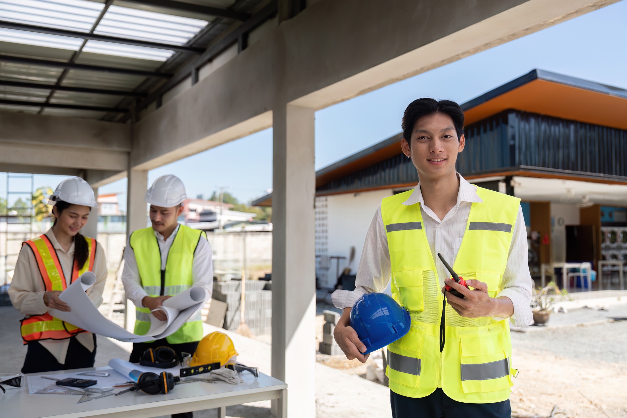 Young Construction Worker with Helmet and Radio. Leadership and Safety on Site
