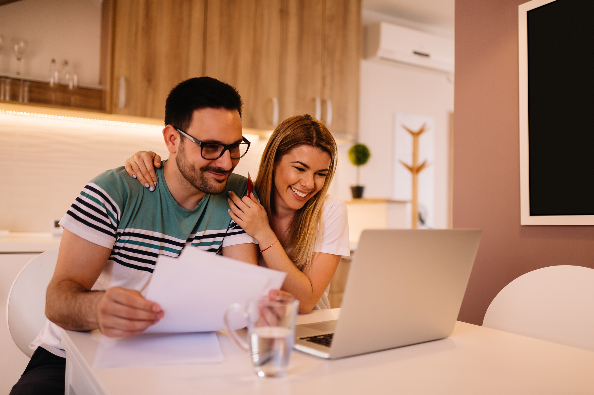 Young couple is smiling while they have Skype call with friends