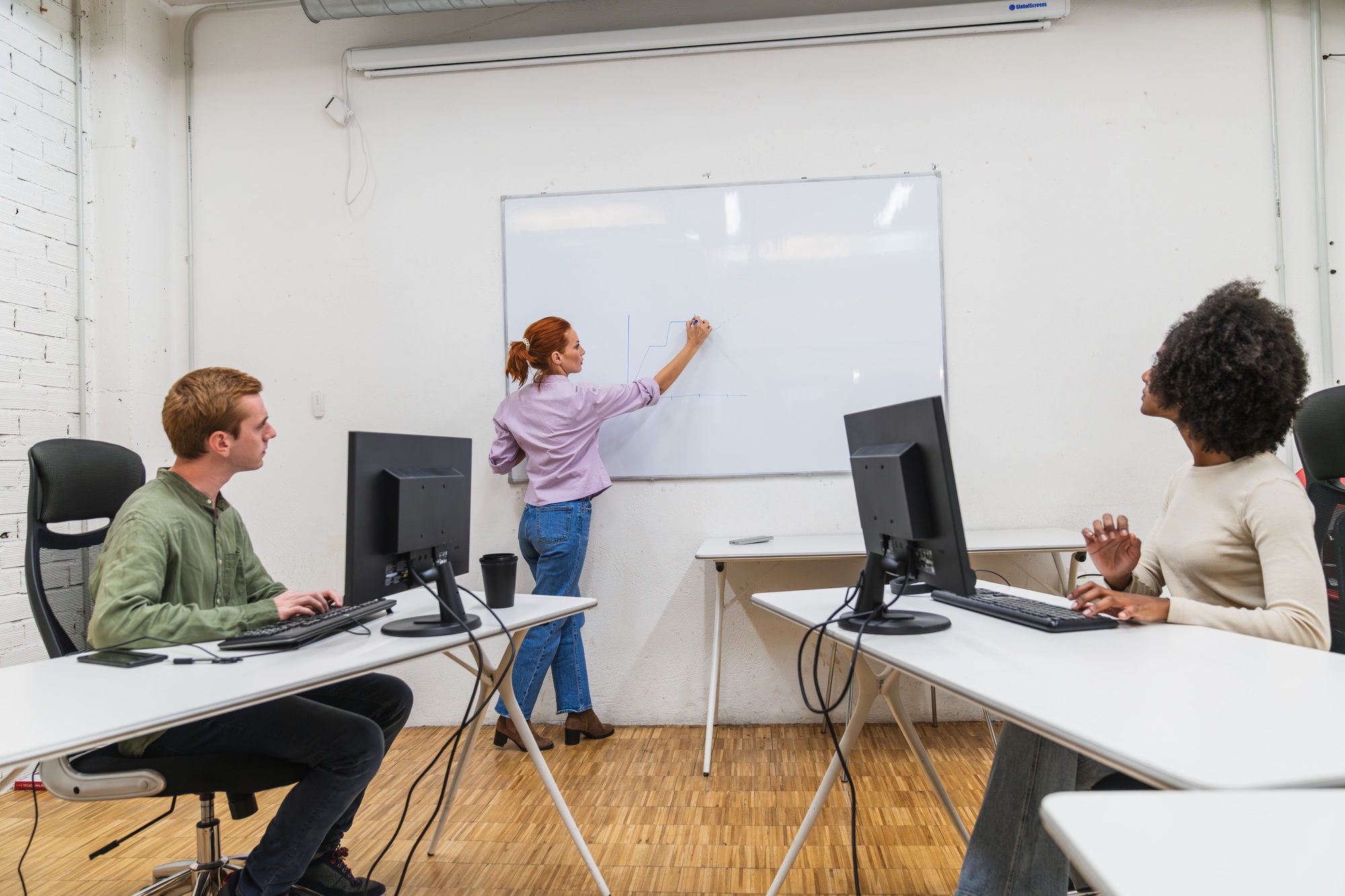 Young professionals collaborating on project in modern coworking space