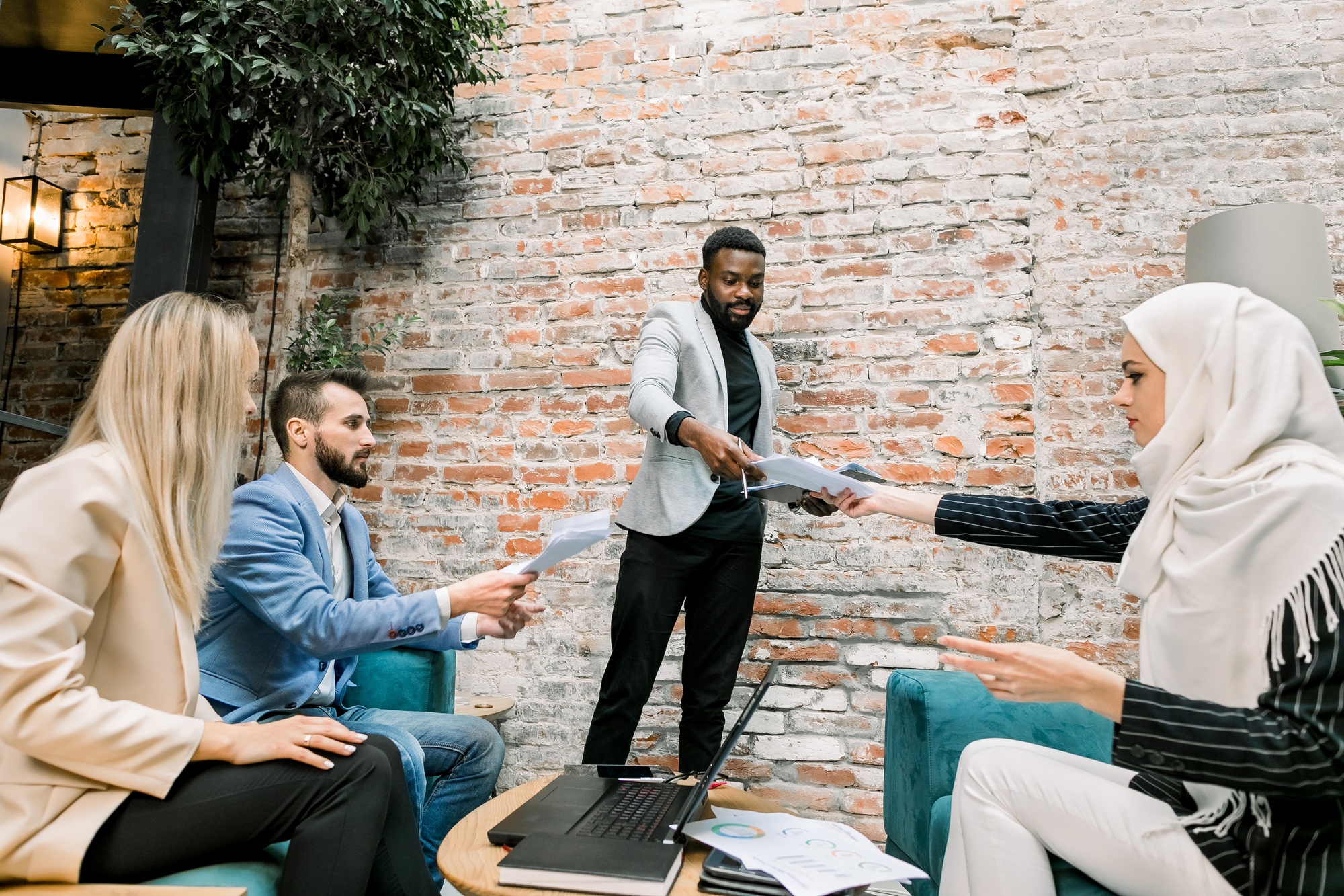 Young talented afro american businessman team leader, giving financial reports with charts and