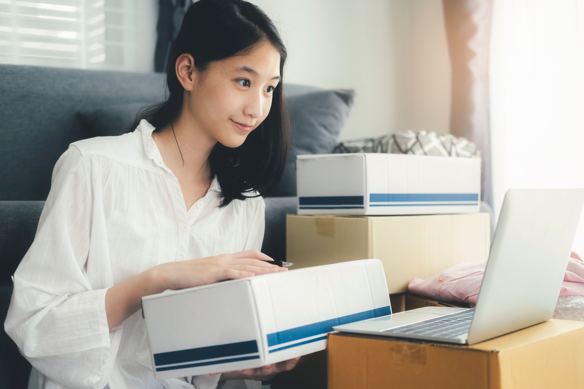 Young woman packing box stock for business shopping online.