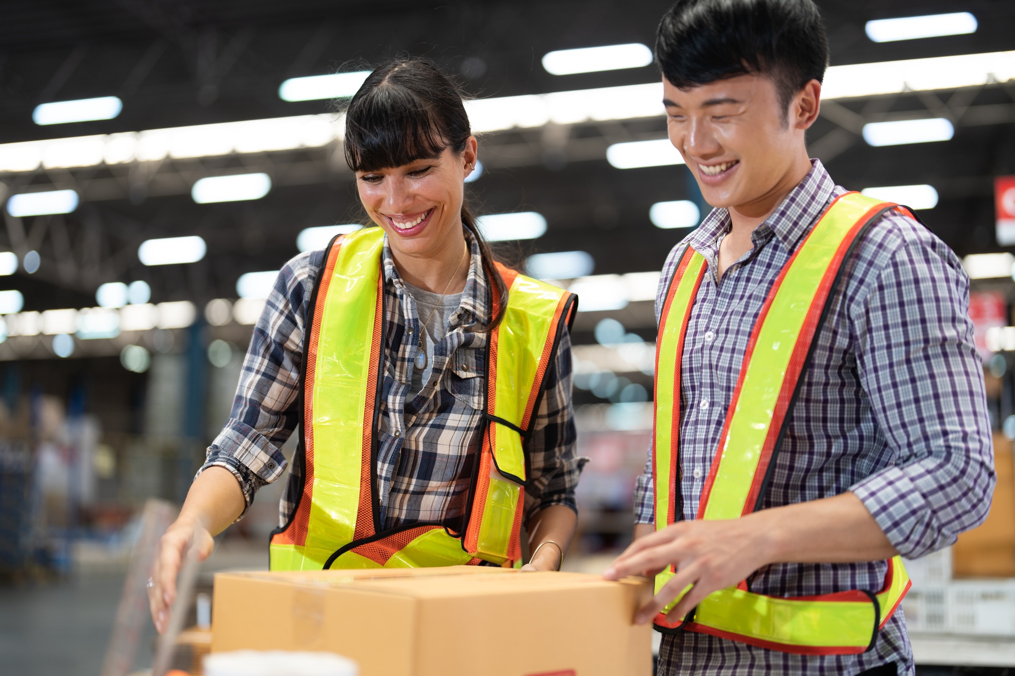 2 staff worker working in the large depot storage warehouse