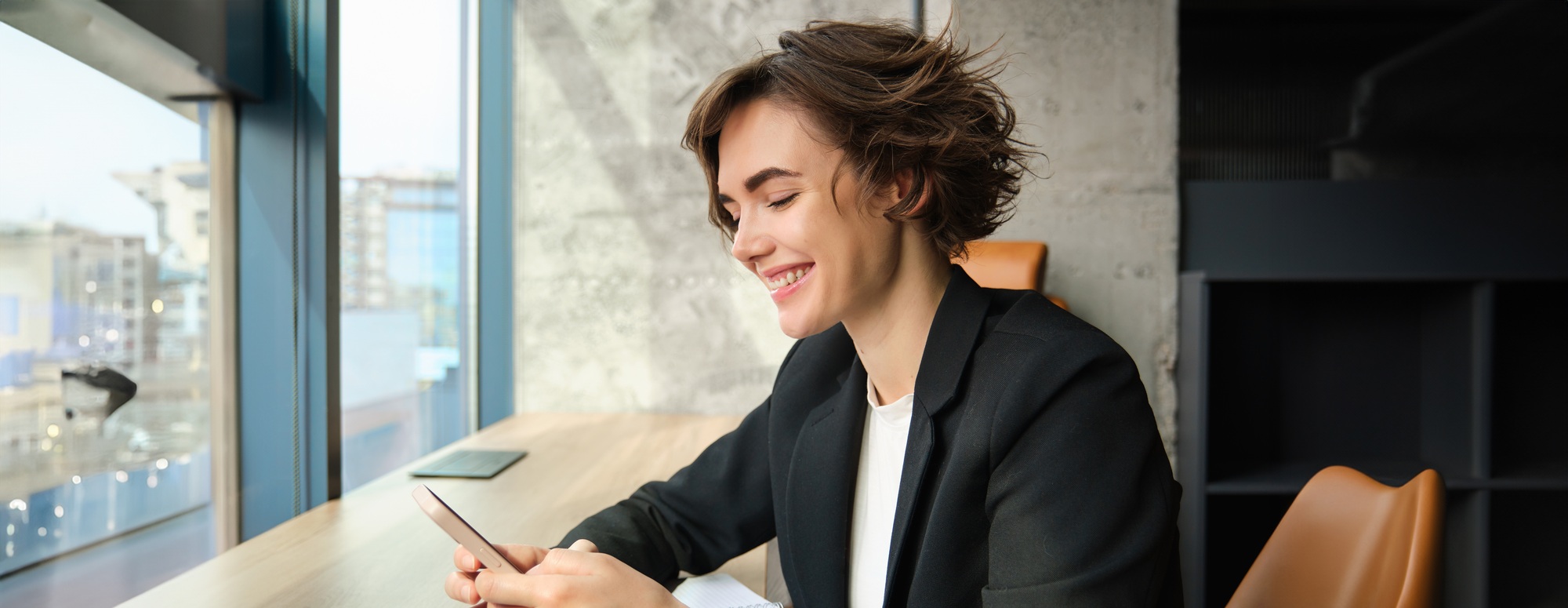 Young woman working in corporate, studying the case in her office, sitting in front of computer in