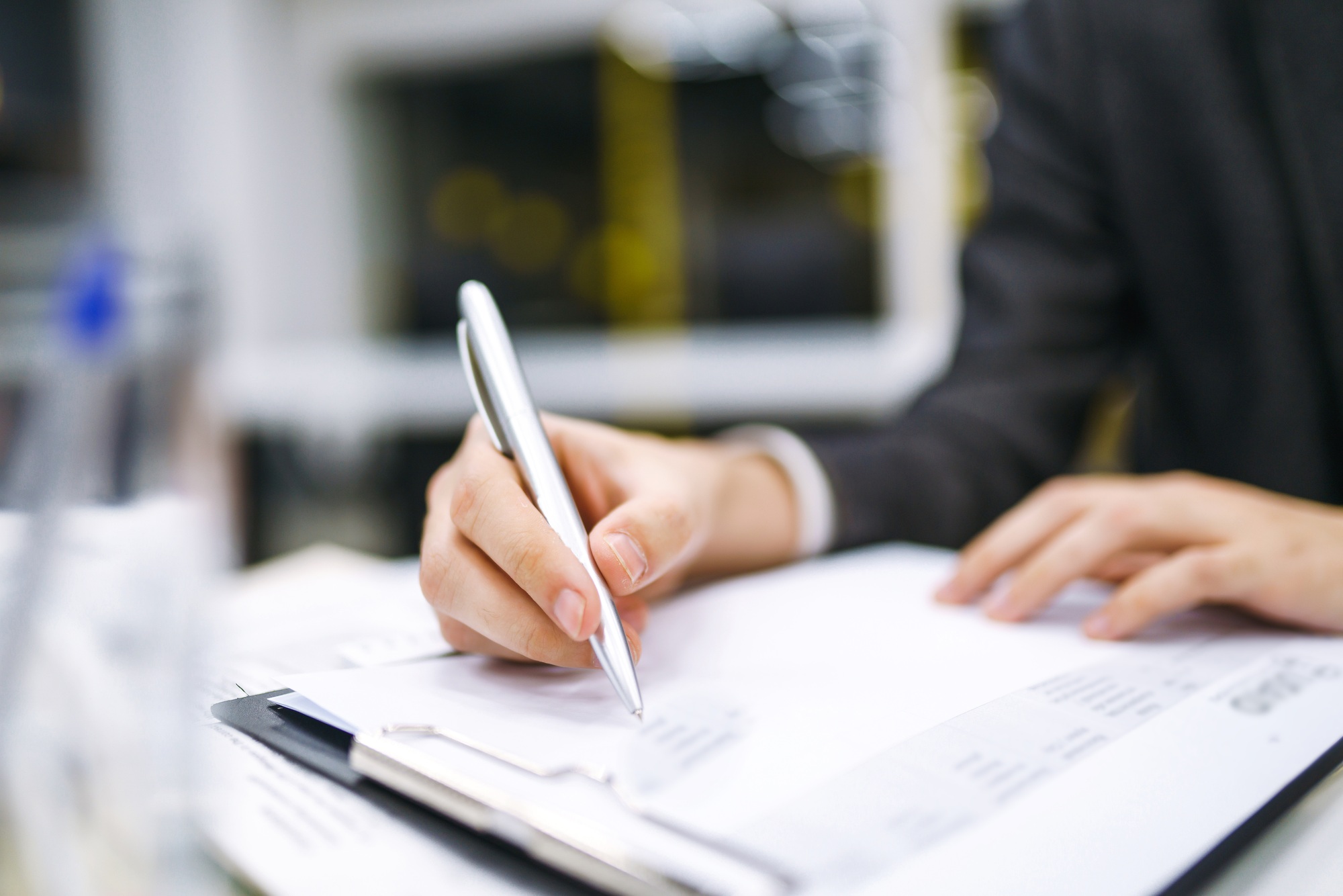 A man signs a contrac, legal or business agreements. Male hand with pen makes notes.