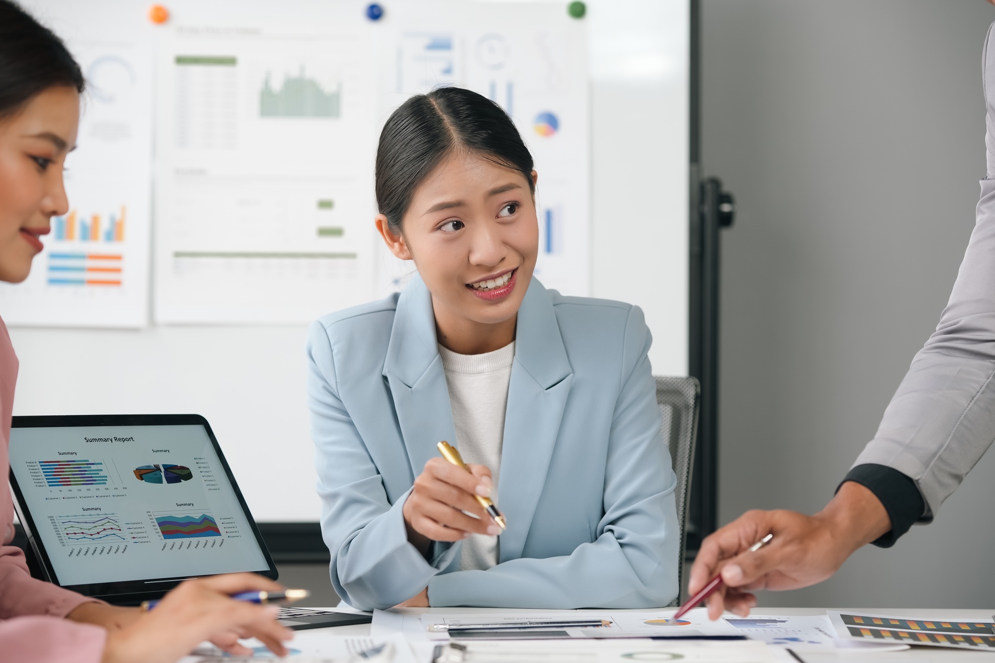 Asian businesswoman leading meeting presenting charts and analysis