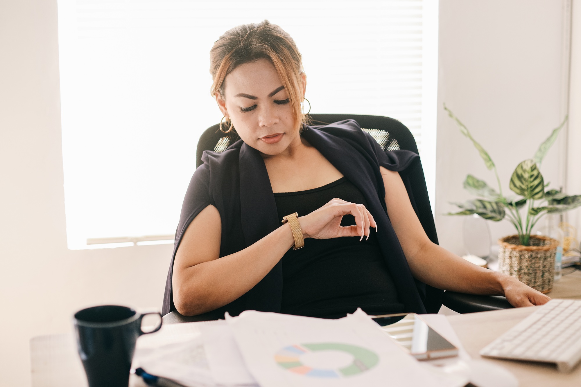 Asian Businesswoman Looking at Wristwatch Waiting an Appointment