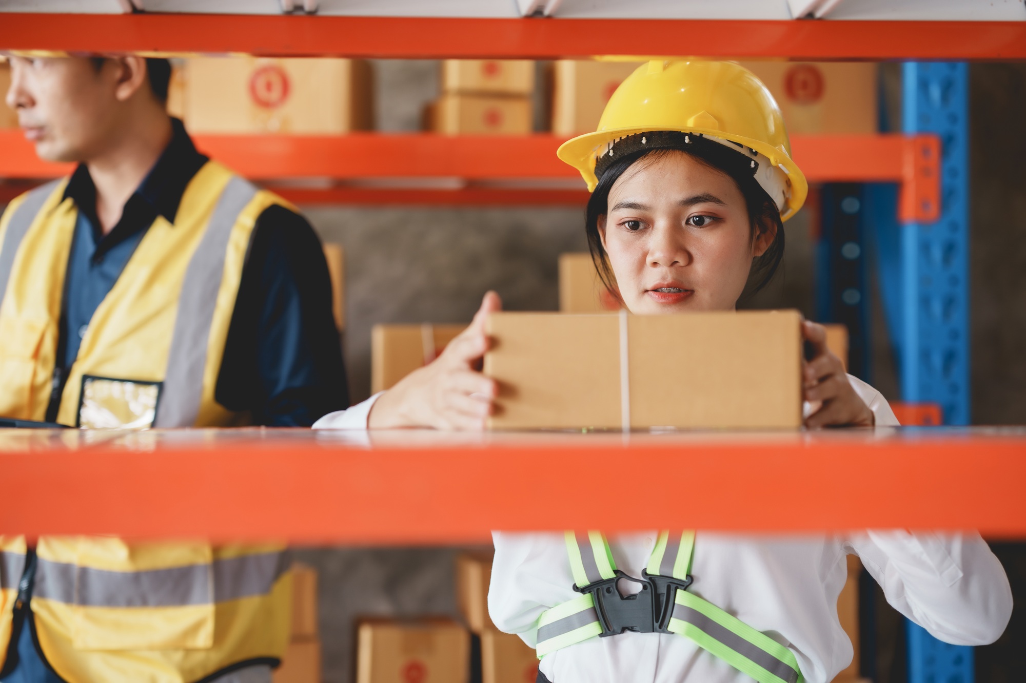 Asian female warehouse worker check and count inventory in the warehouse for accuracy and ease