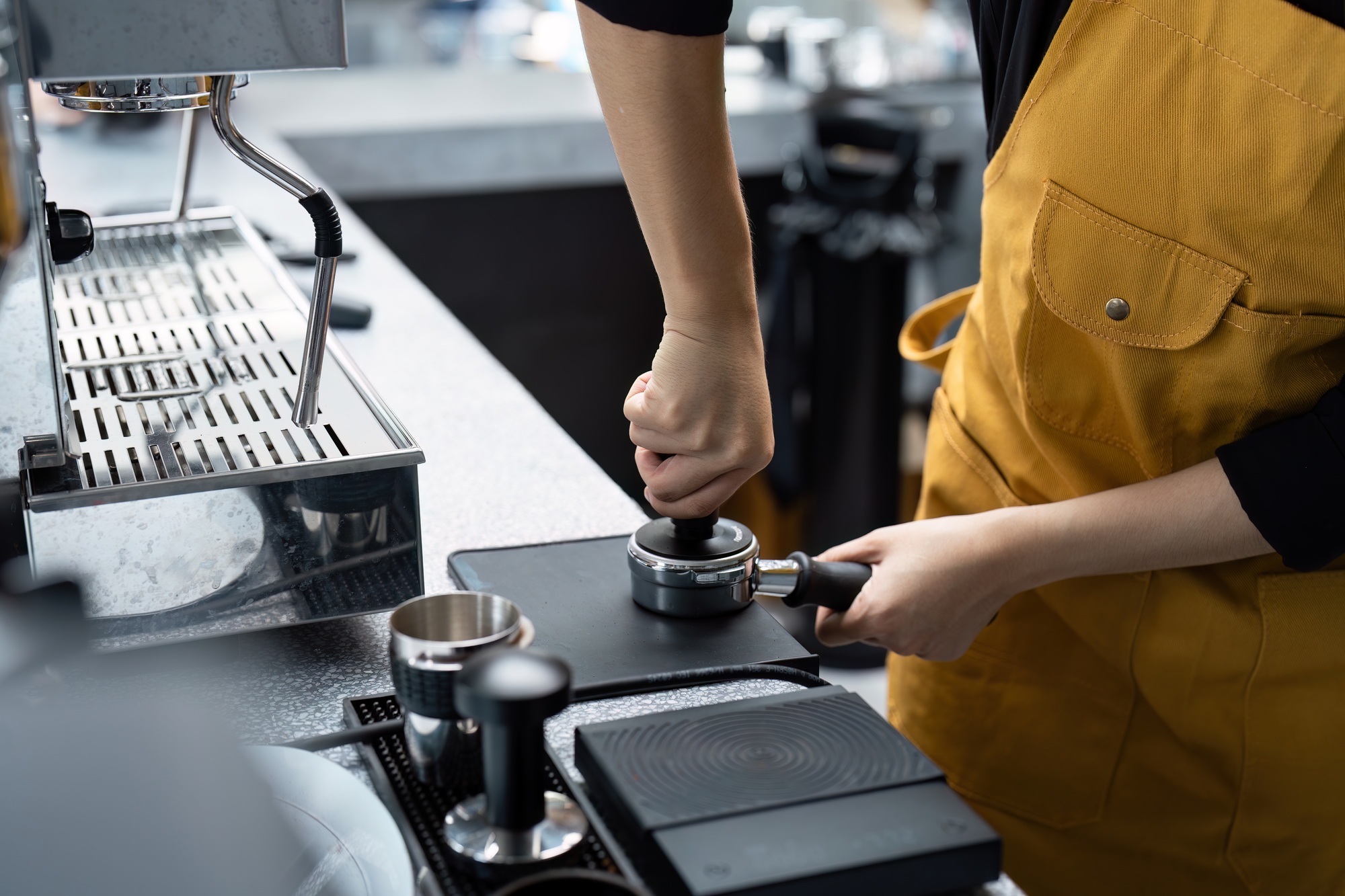 Barista Crafting Coffee in a Modern Small Business Startup Cafe Setting