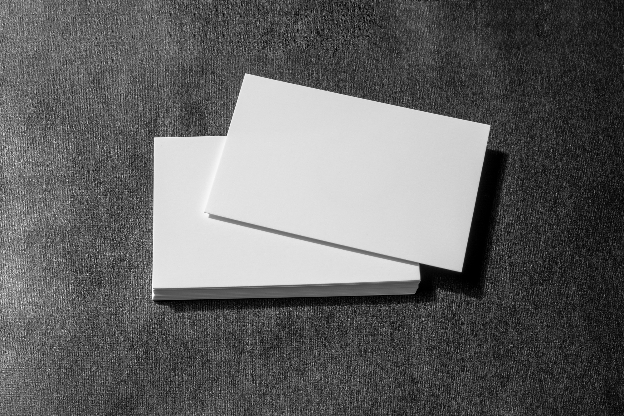 blank business card stack mock up for branding identity  isolated on black paper texture