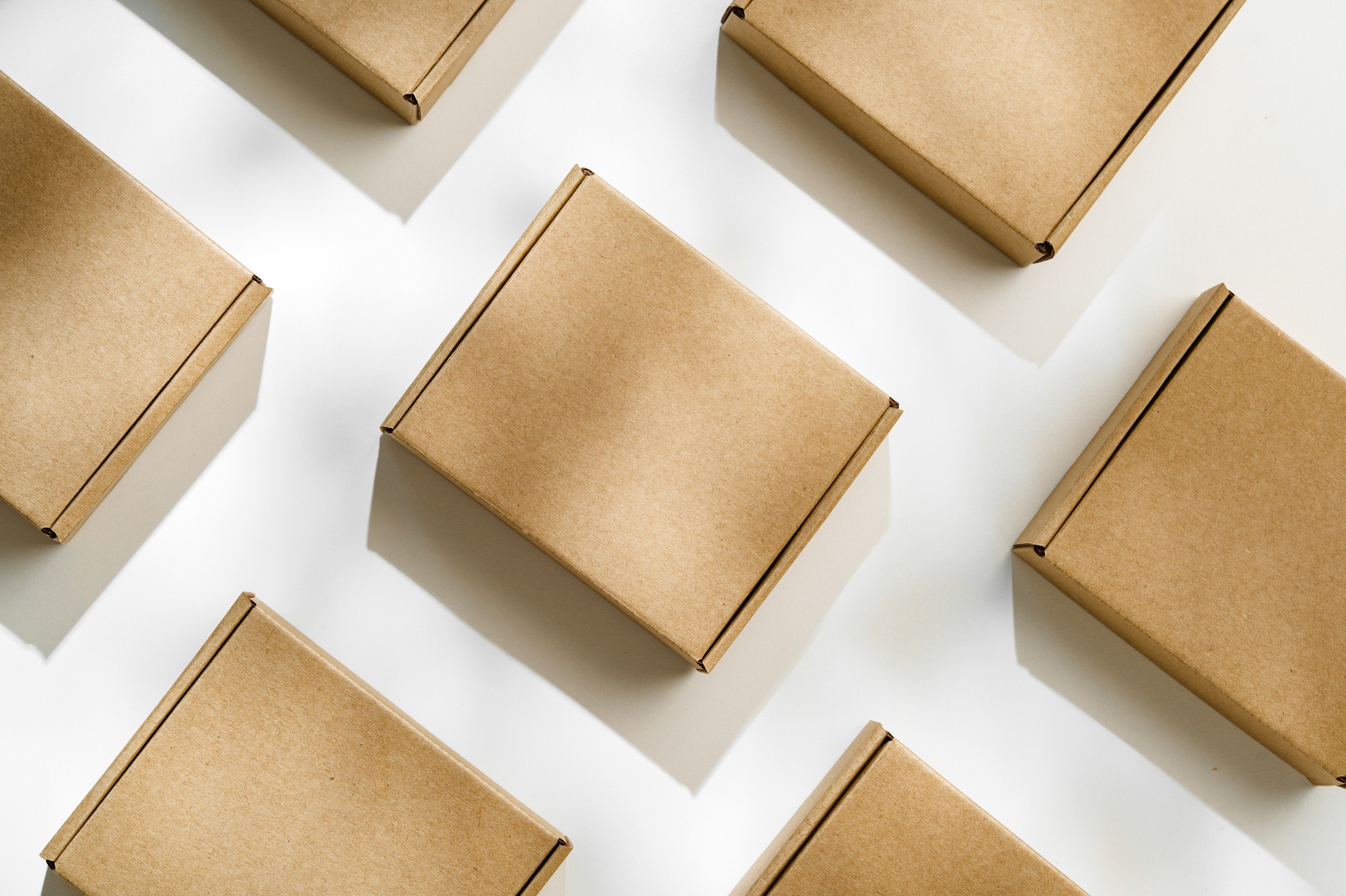 Brown cardboard boxes arranged on a light surface for packing goods in a warehouse setting