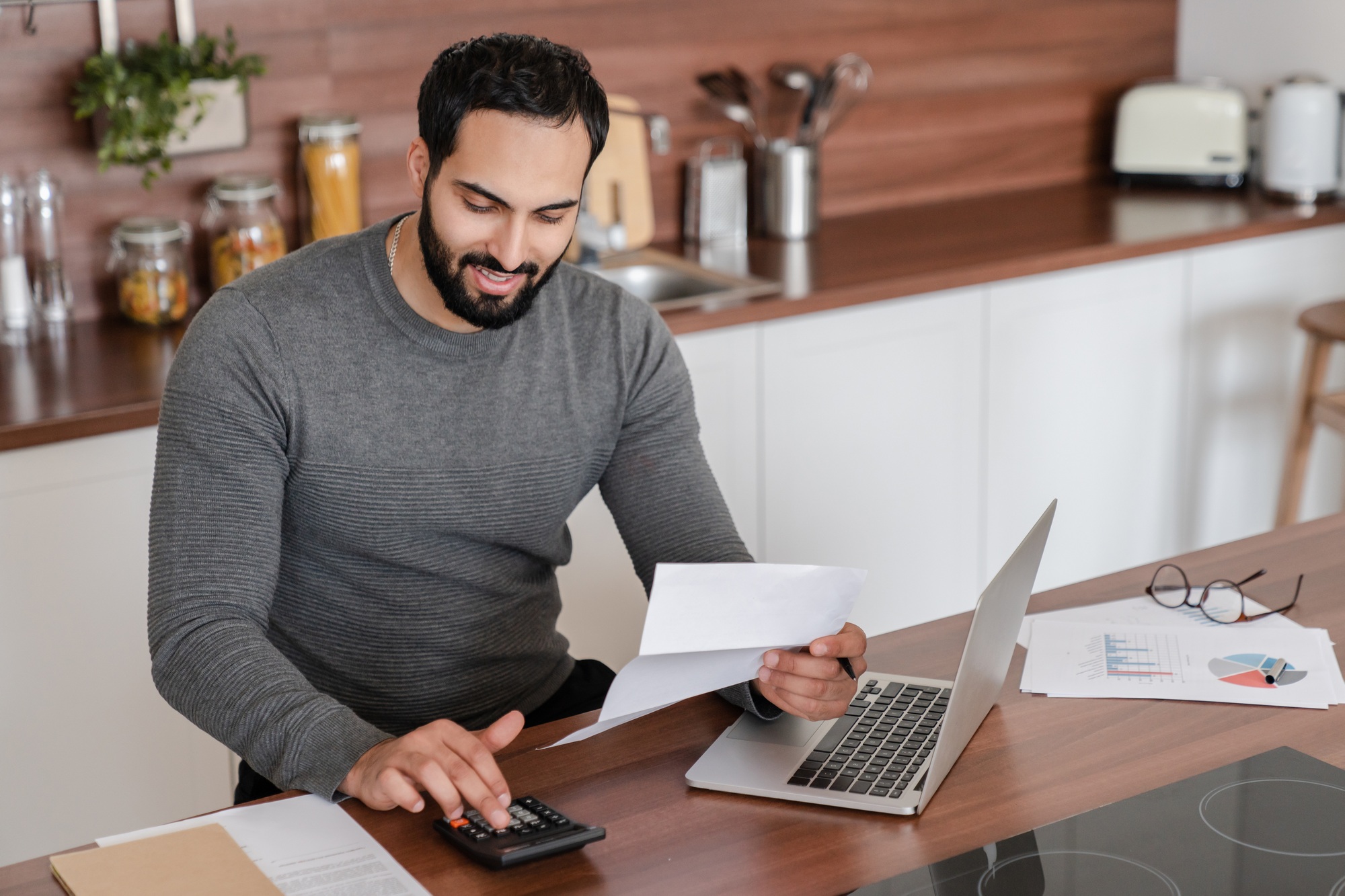 Business and economy concept. Arabian man freelancer student counting calculating costs