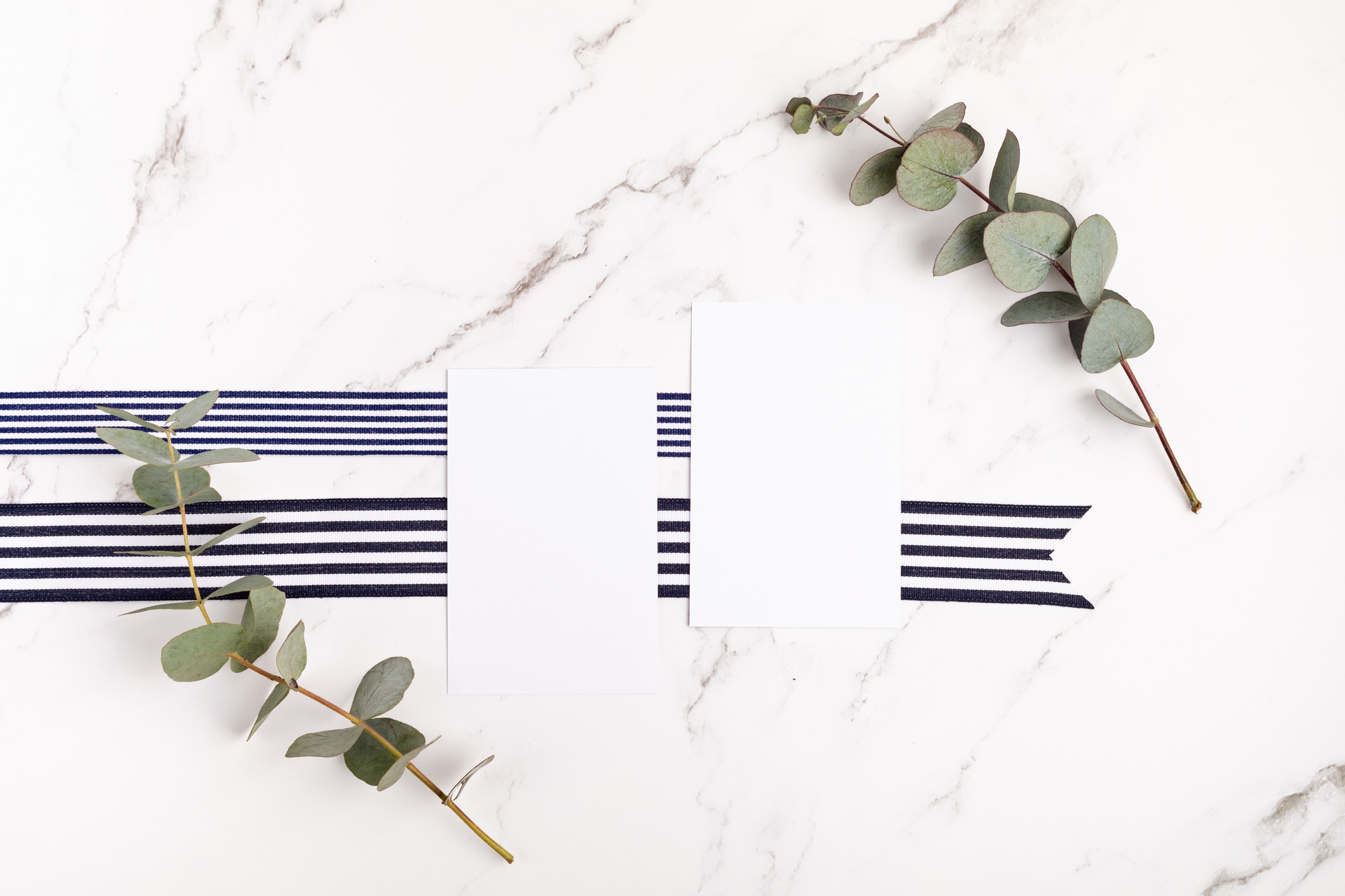 Business cards branding mockup on light background with ribbon and floral elements