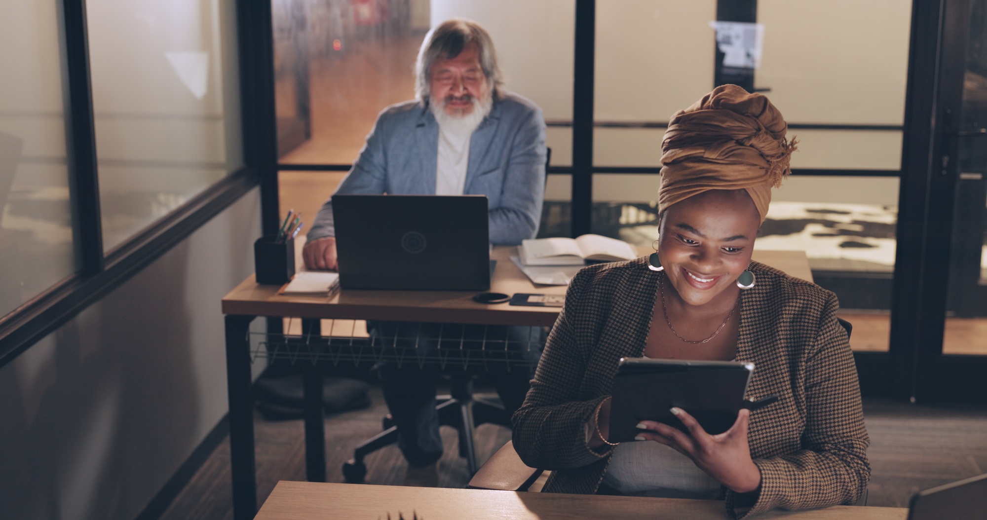 Business, tablet and black woman in office, night and online schedule. Staff, African American fema