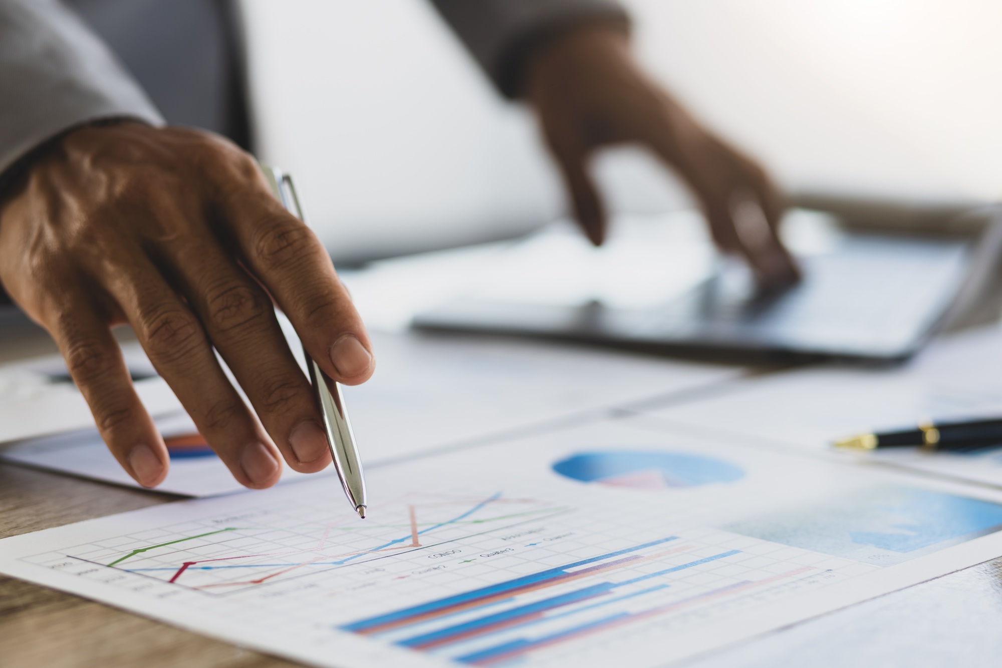 Businessman analyzing business growth marketing report. Business and financial strategy planning.