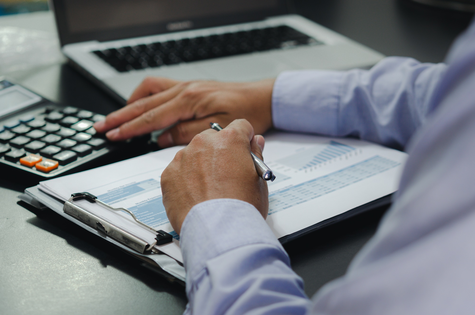 businessman hands holding pens and business documents