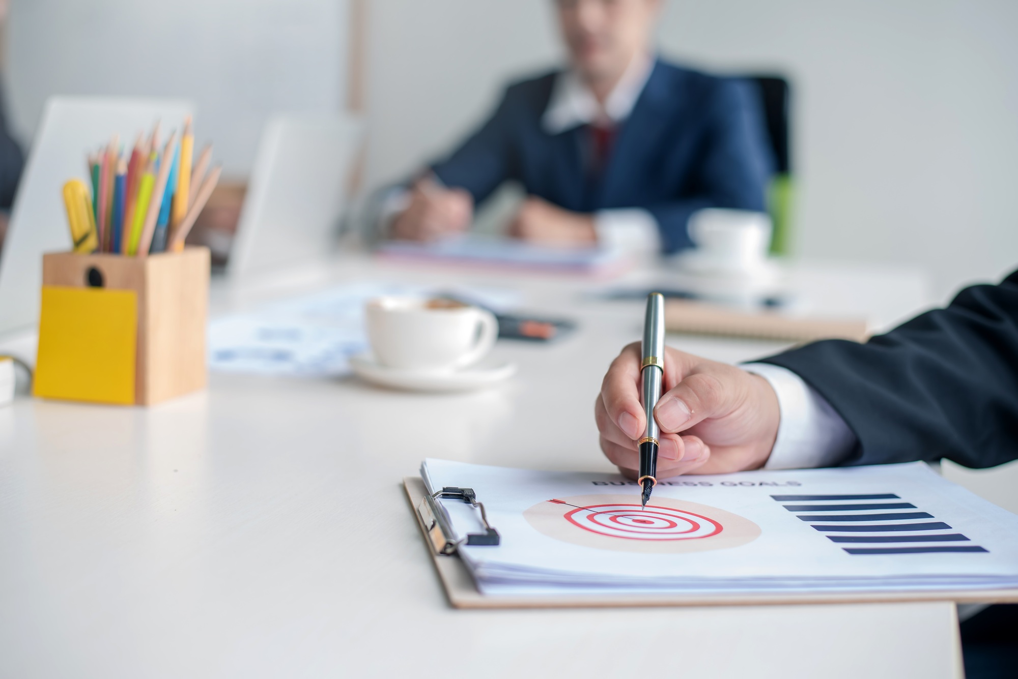 Businessman pointing to goal on document during the meeting.