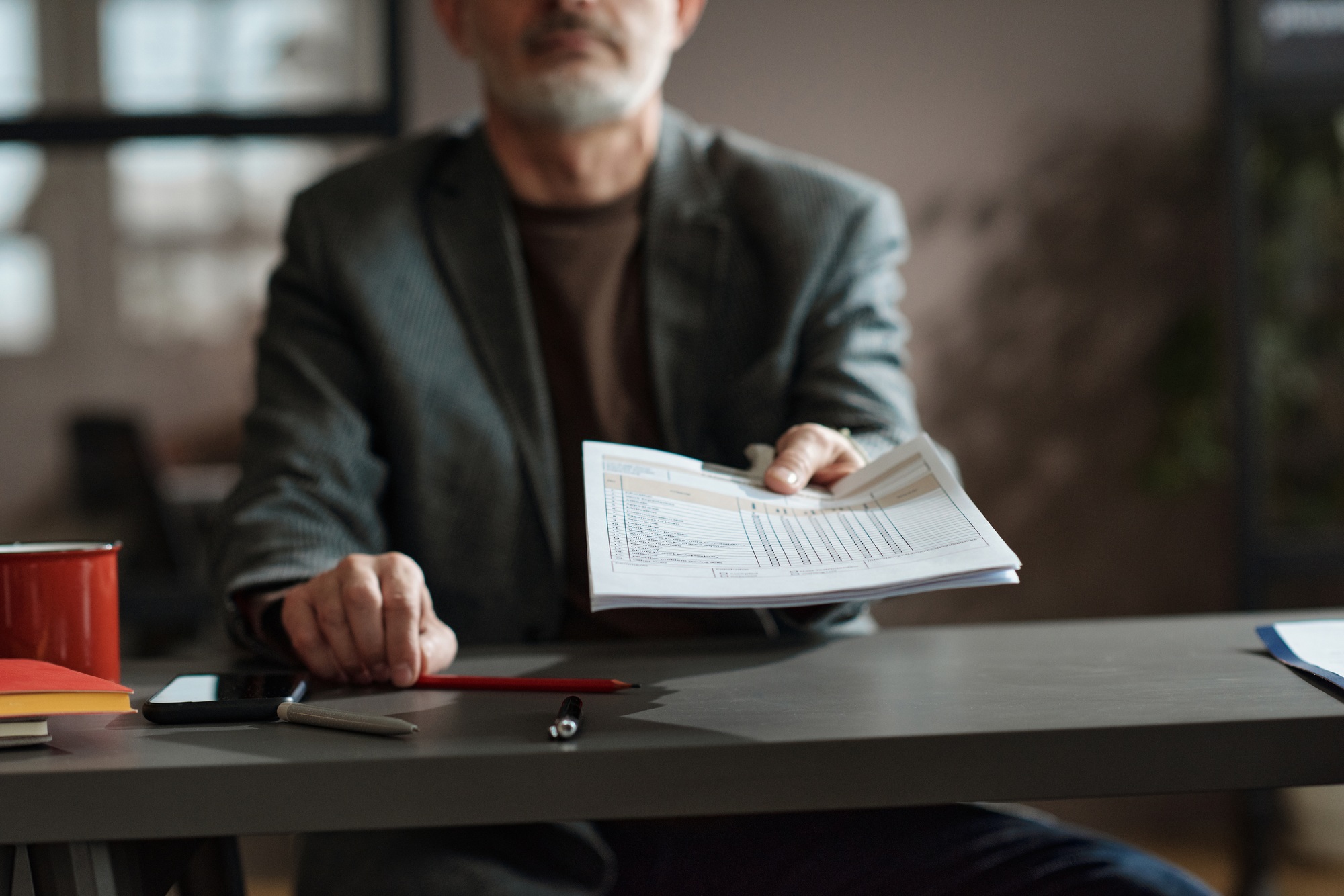 Businessman suggesting to fill the form at meeting