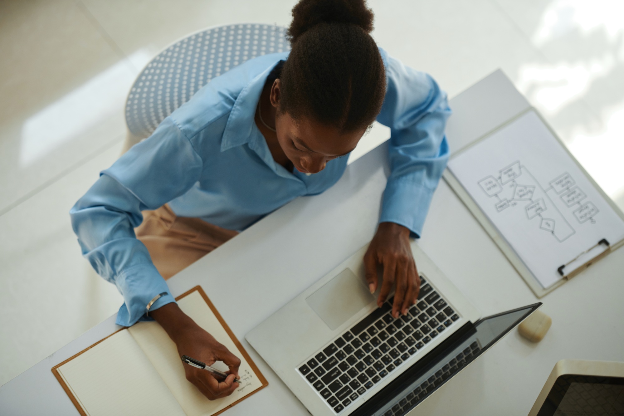 Businesswoman Checking Schedule and Writing in Planner