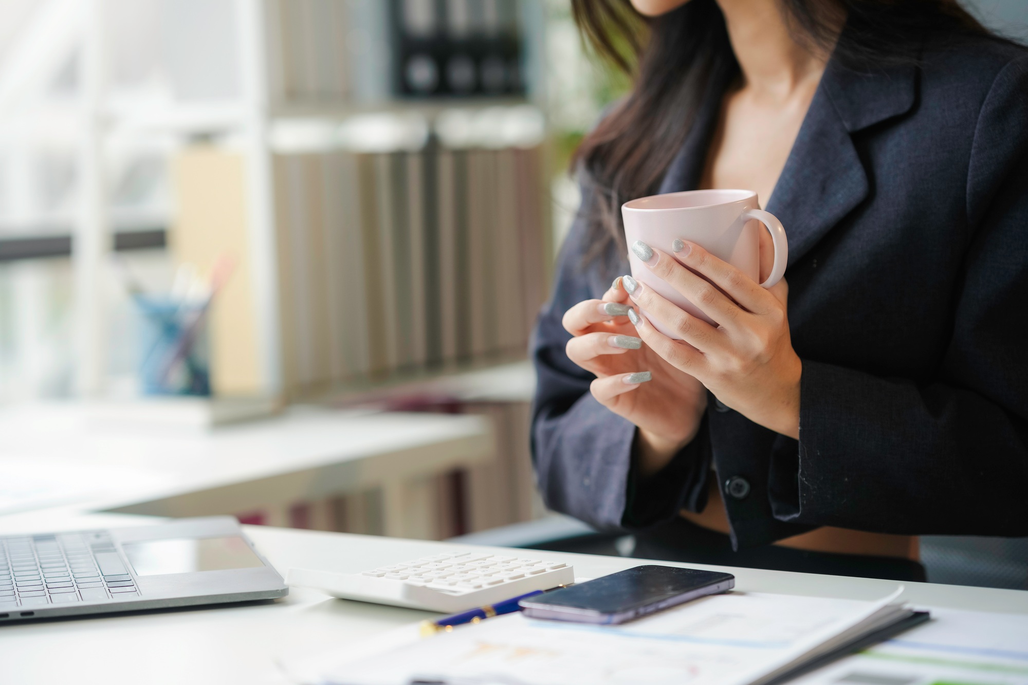 Businesswoman holding a cup of coffee during a break in the office