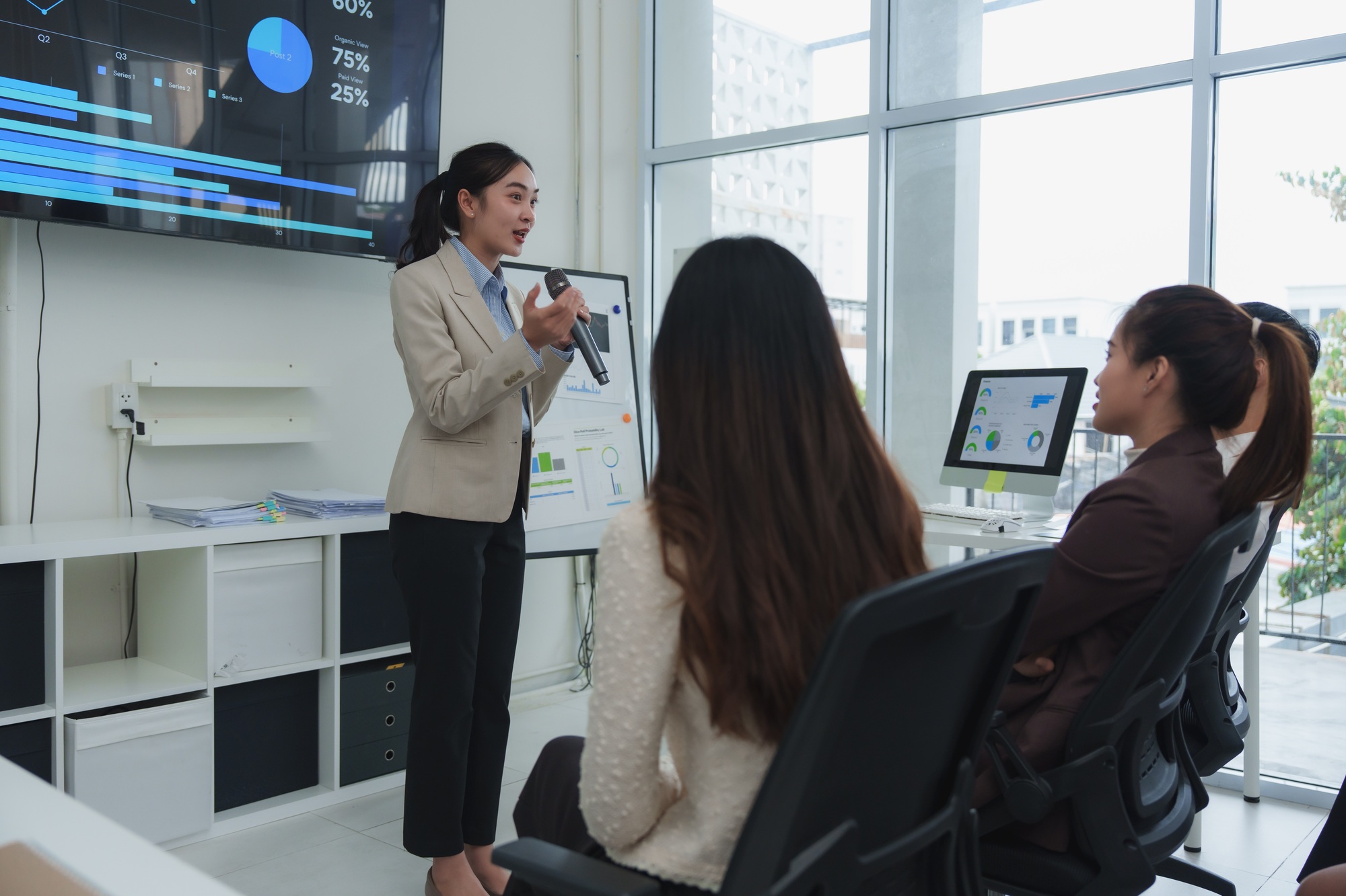Businesswoman presenting sales data in modern office