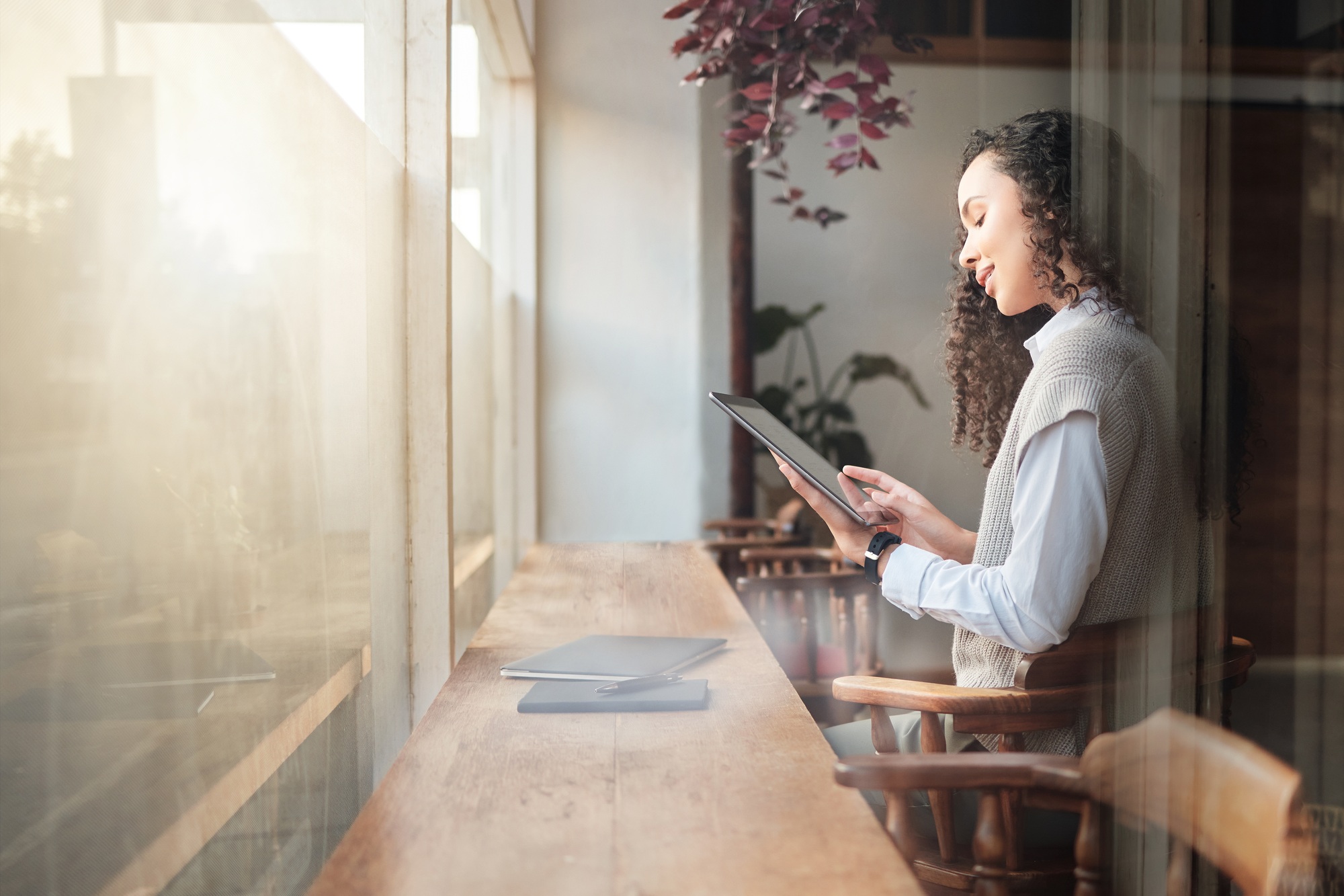 Cafe, tablet and business woman reading report, research statistics or customer experience feedback
