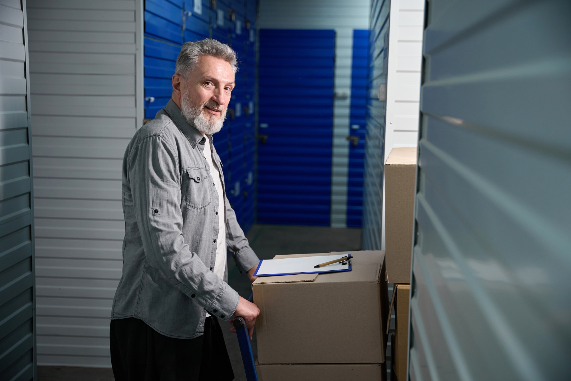 Client carrying large trolley filled with stacked boxes