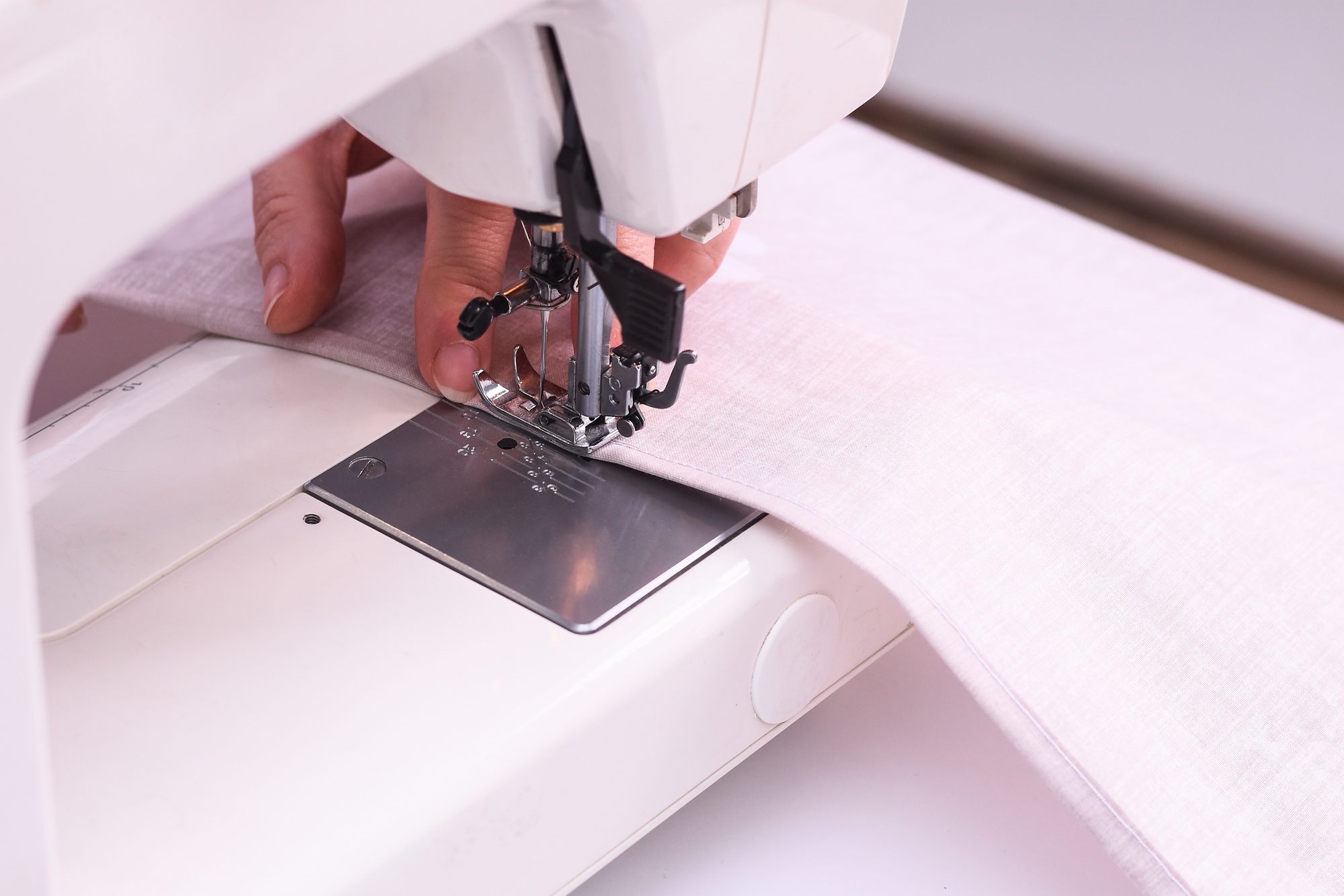 Close-up image of seamstress. Seamstress sews fulfills an order.