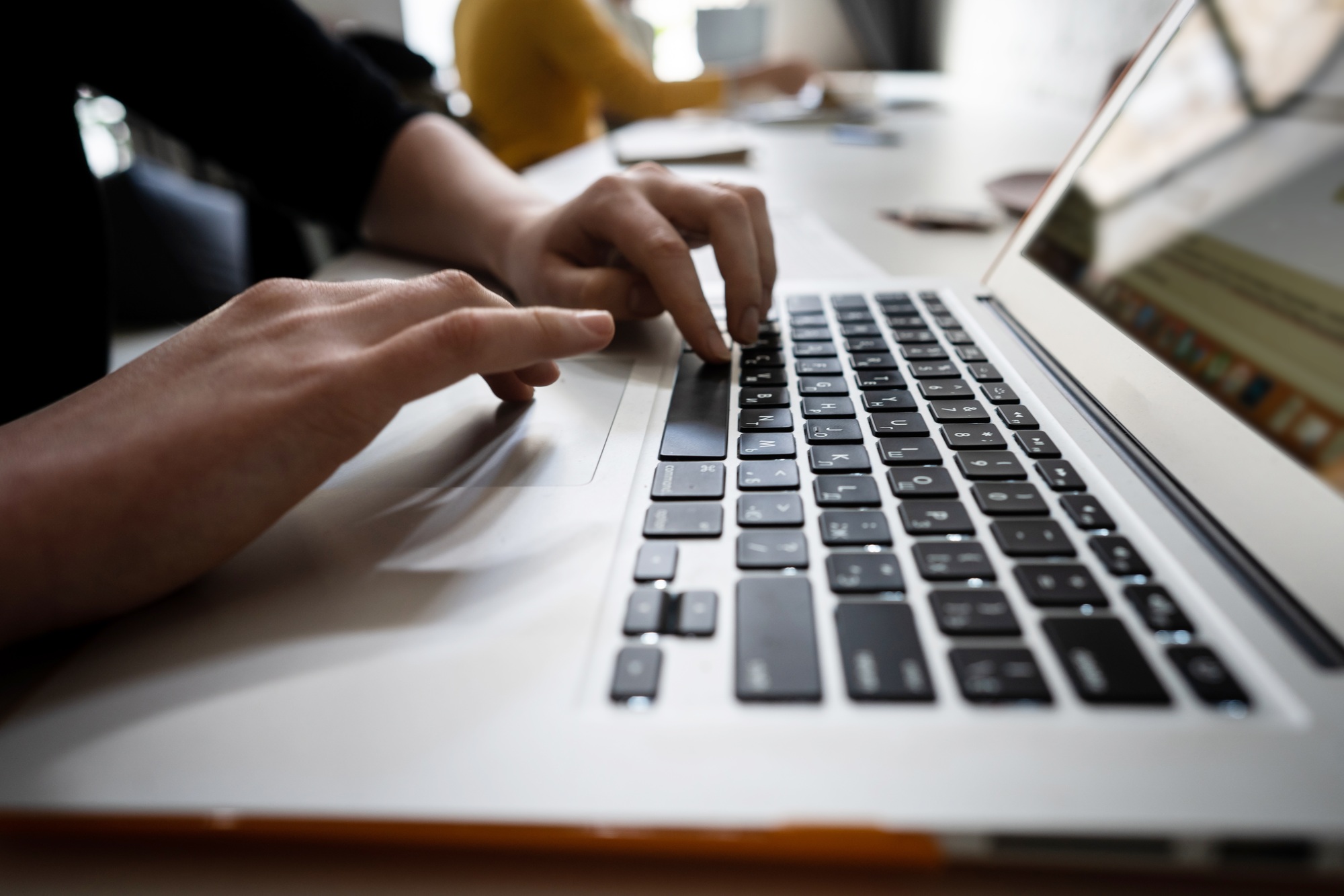 Close-up of hands of businessman typing on a laptop