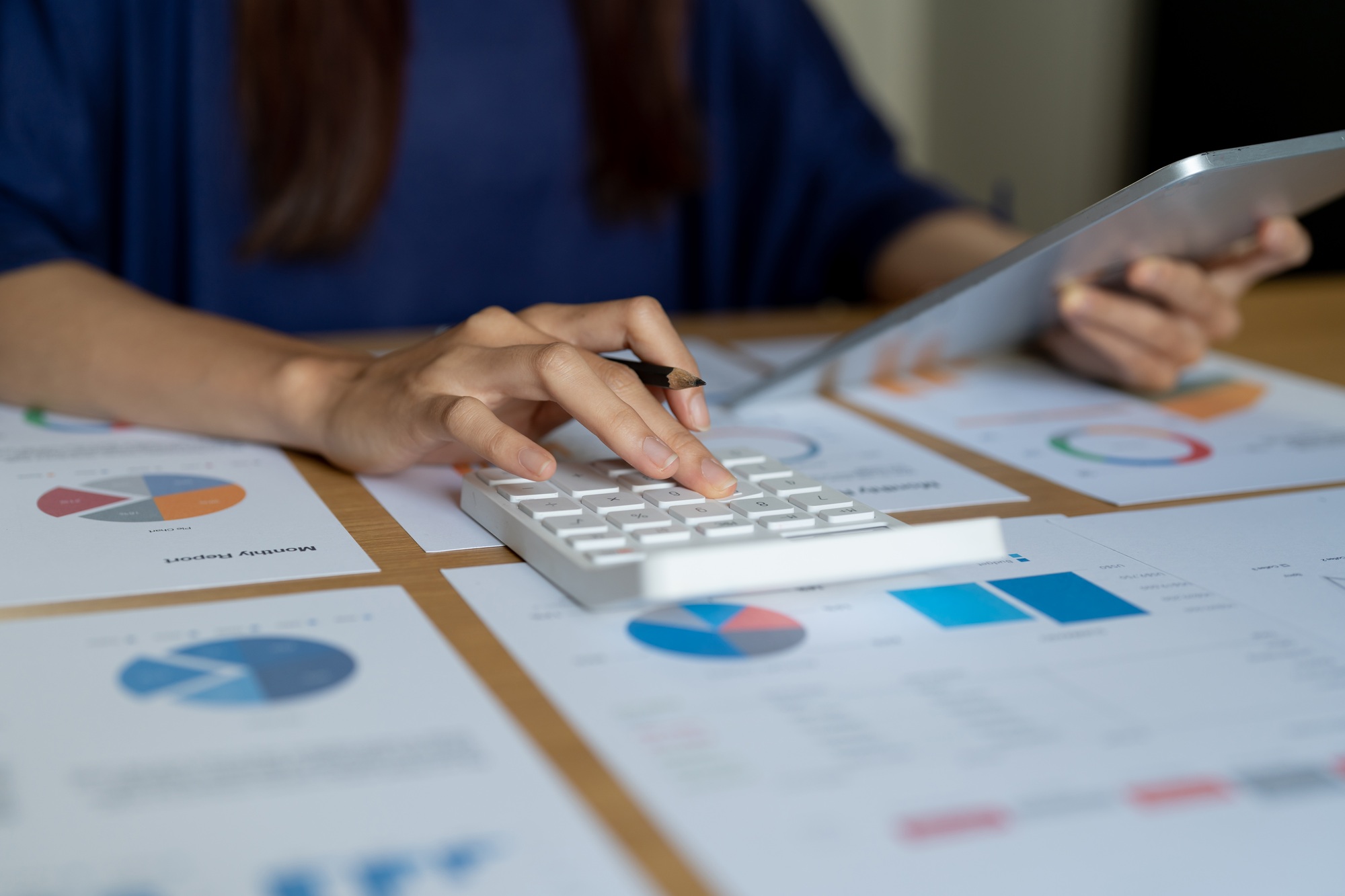 Close up woman doing financial audit, managing household budget, planning investment, making