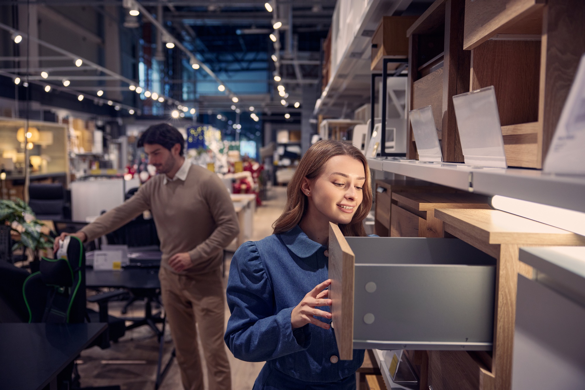 Couple explores various modern furniture options in stylish store highlighting unique designs