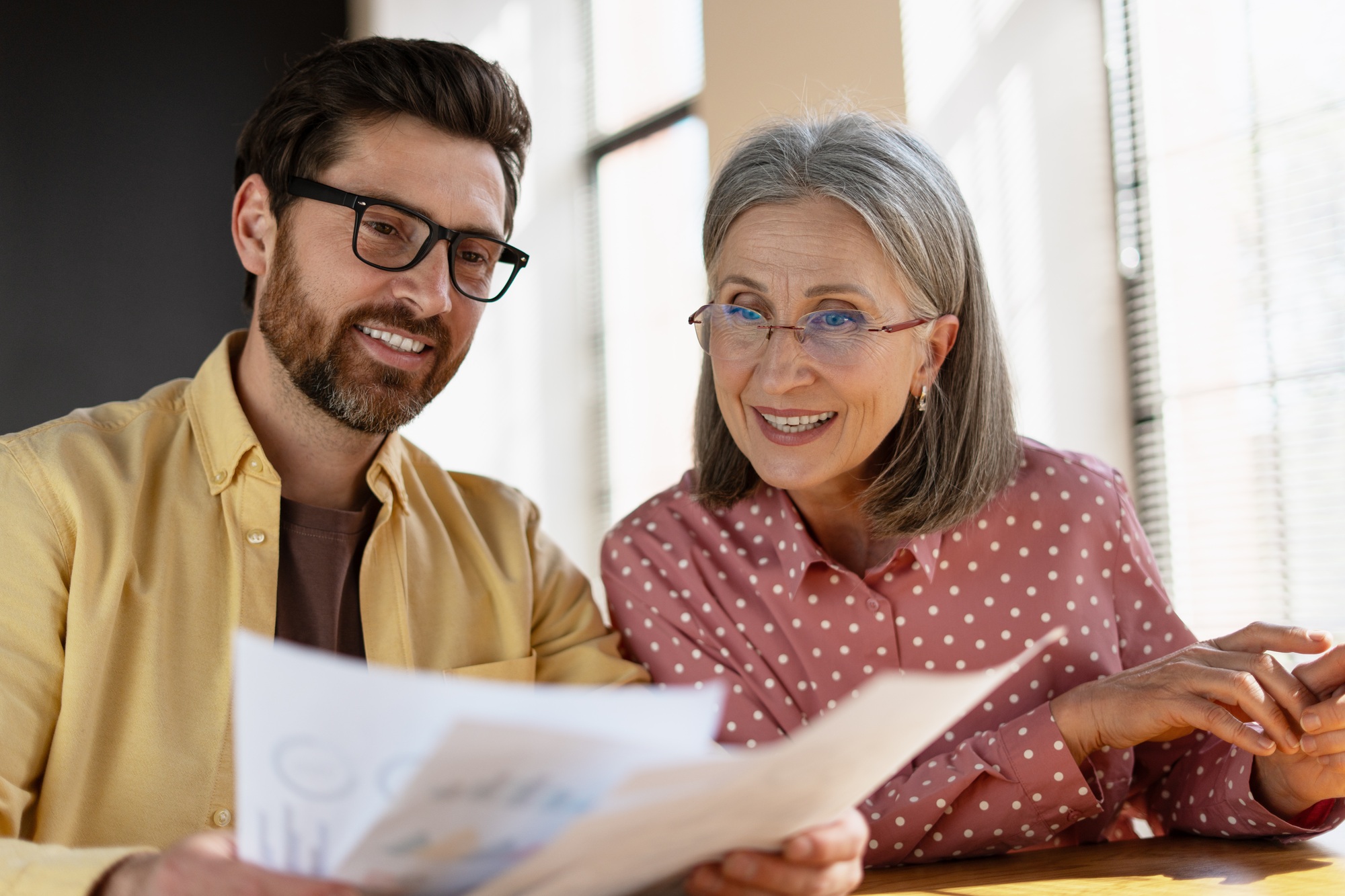 Coworkers reviewing financial report together in the office