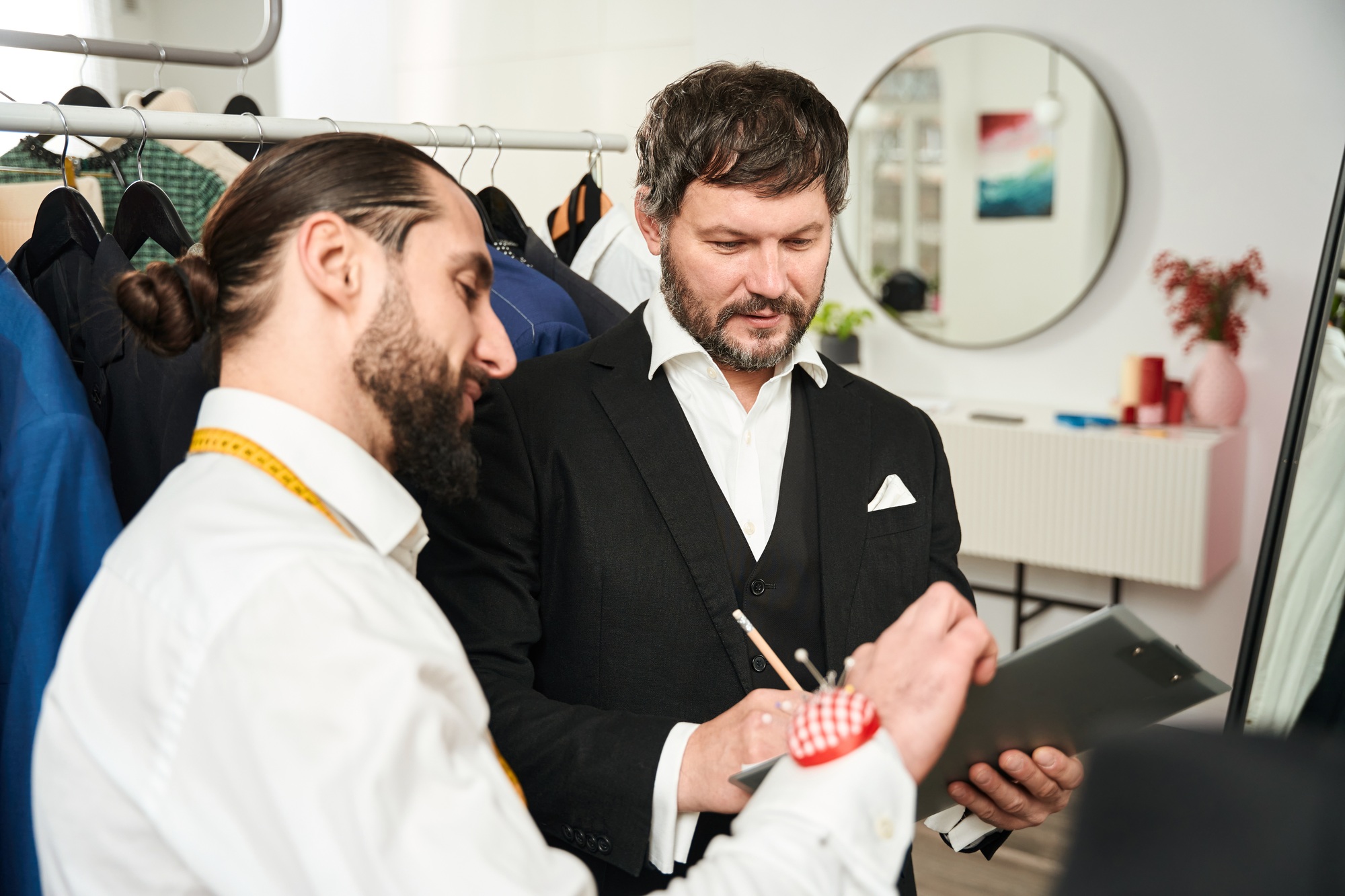 Customer filling in document with help of clothier