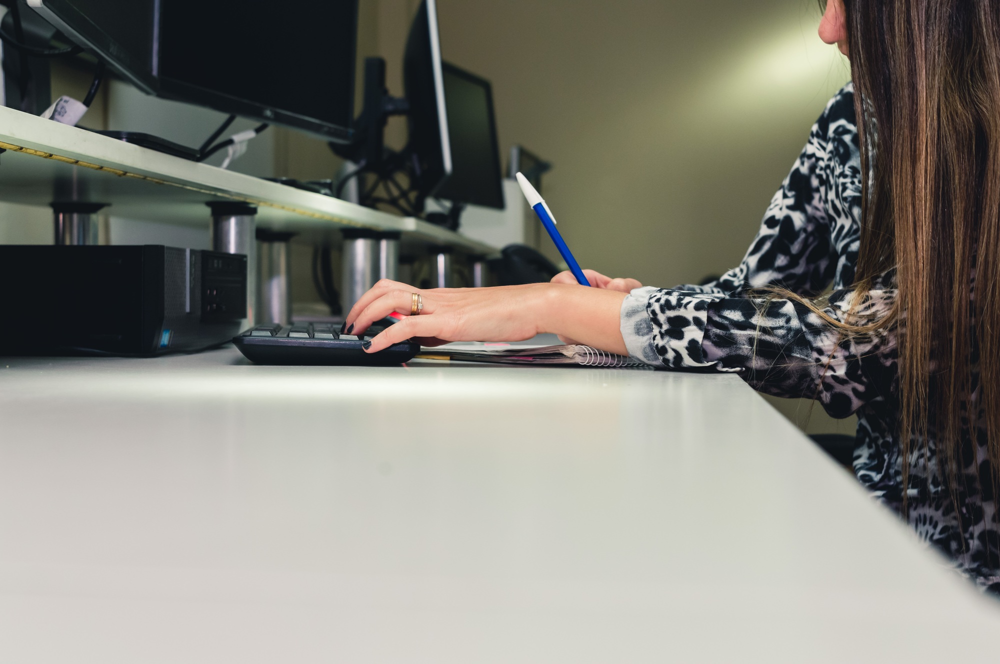 female employee in software programming office writing notes from clients, copy space
