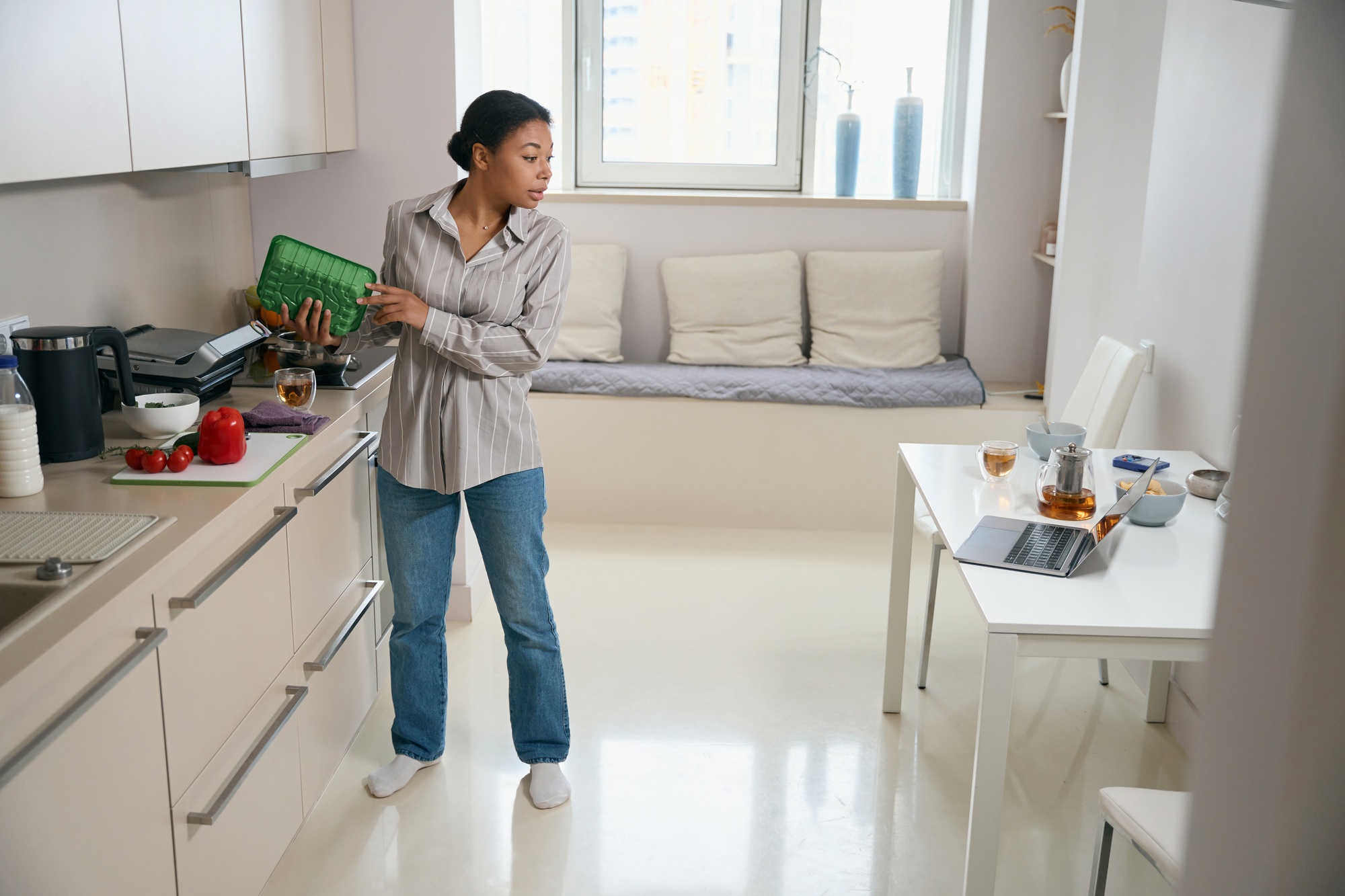 Focused African woman is doing many task t the same time in cuisine