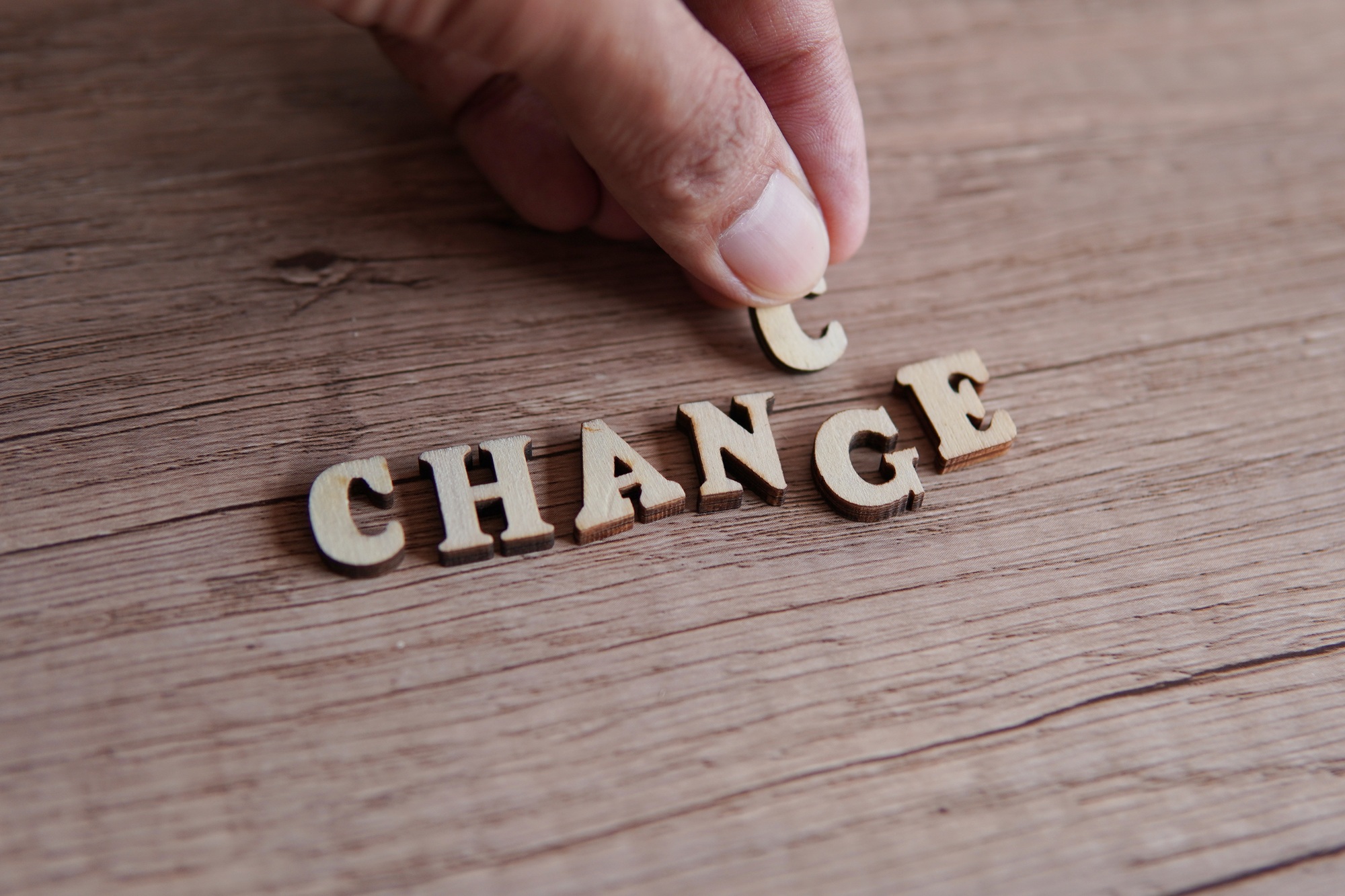 Hand changing the word Change into Chance.