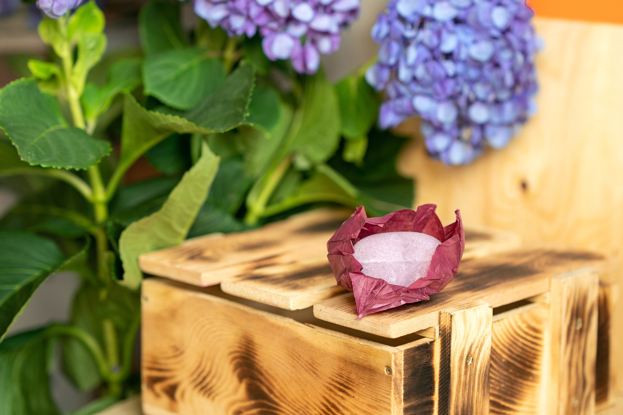 Handmade bath bomb or soap on a wooden box.