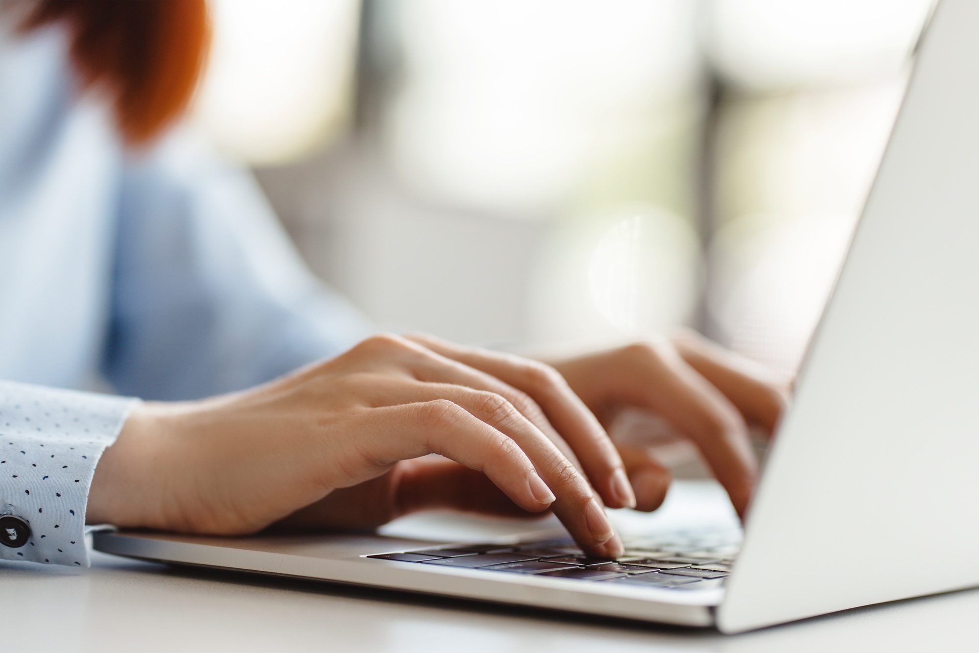 Hands typing on keyboard, working online office. Programmer, coder using laptop computer