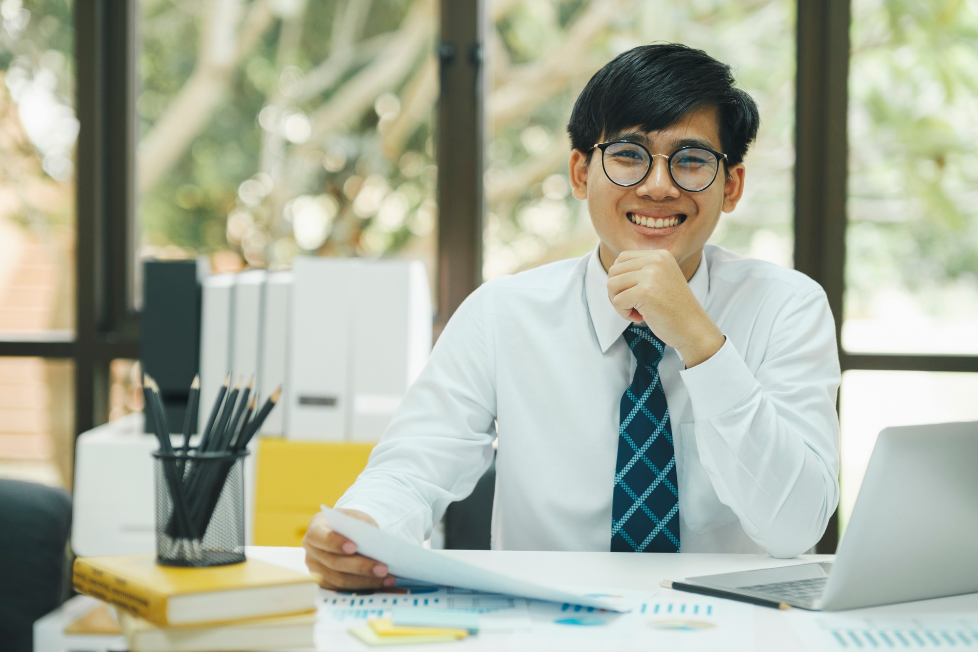Happy asian businessman about investment market data analysis.