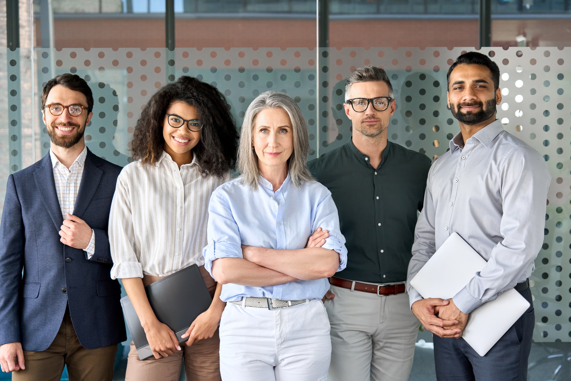 Happy diverse business people team standing in office, group portrait.