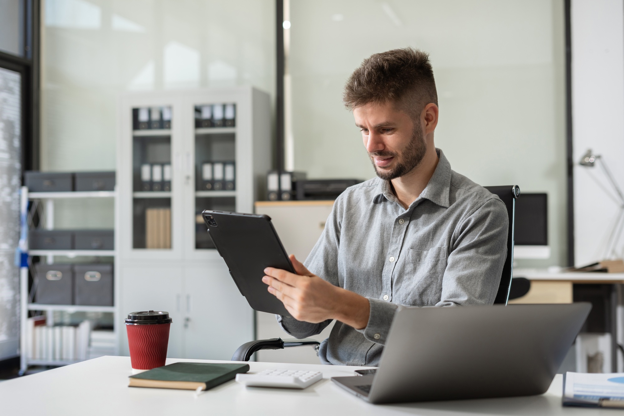 Happy man, entrepreneur, small business owner working online.