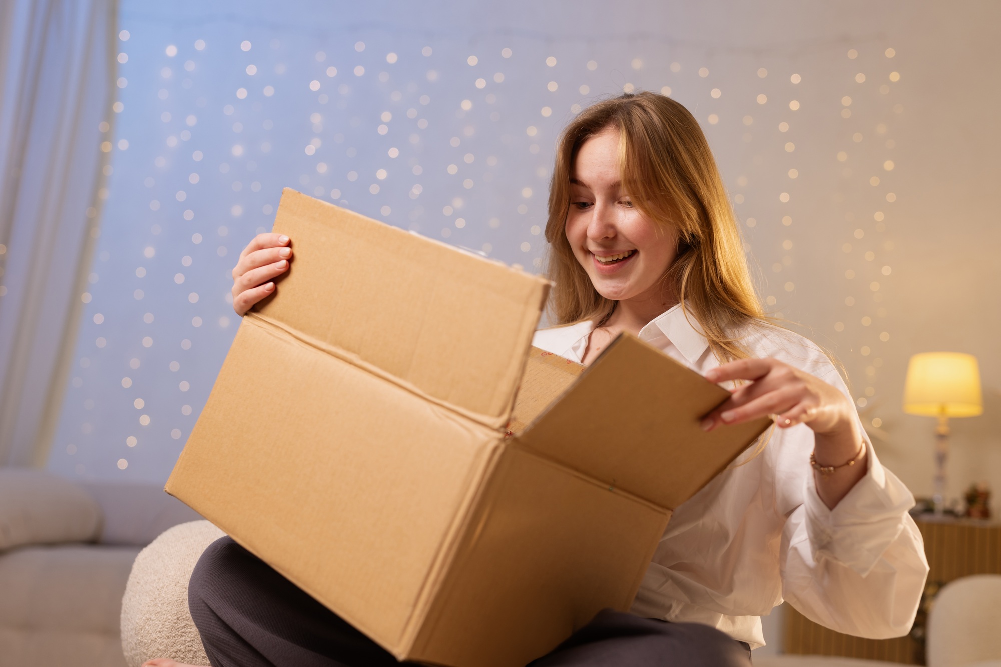 Happy Woman Opening Package at Home Representing Online Shopping Delivery and Unboxing Experience