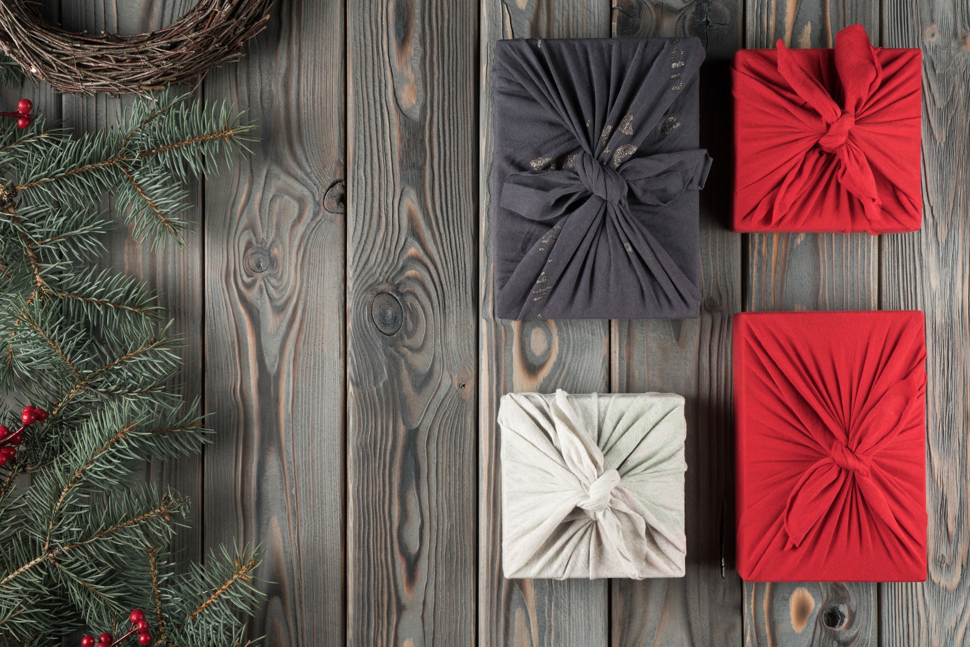 Holiday composition handmade, craft, wrapped Furoshiki present boxes with decorated fir tree