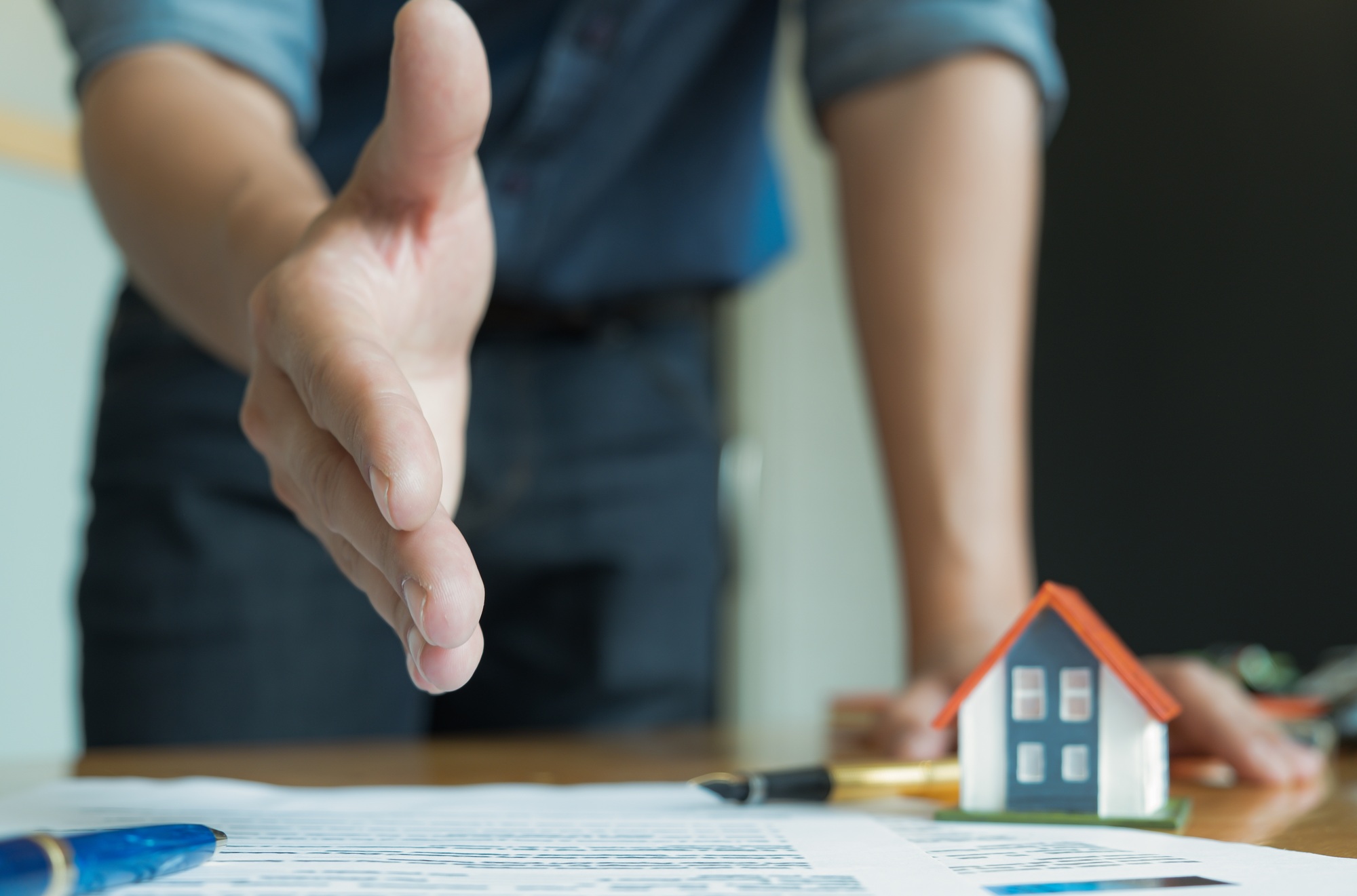 House sales staff extended their hands in front. Join hands with customers to close sales.