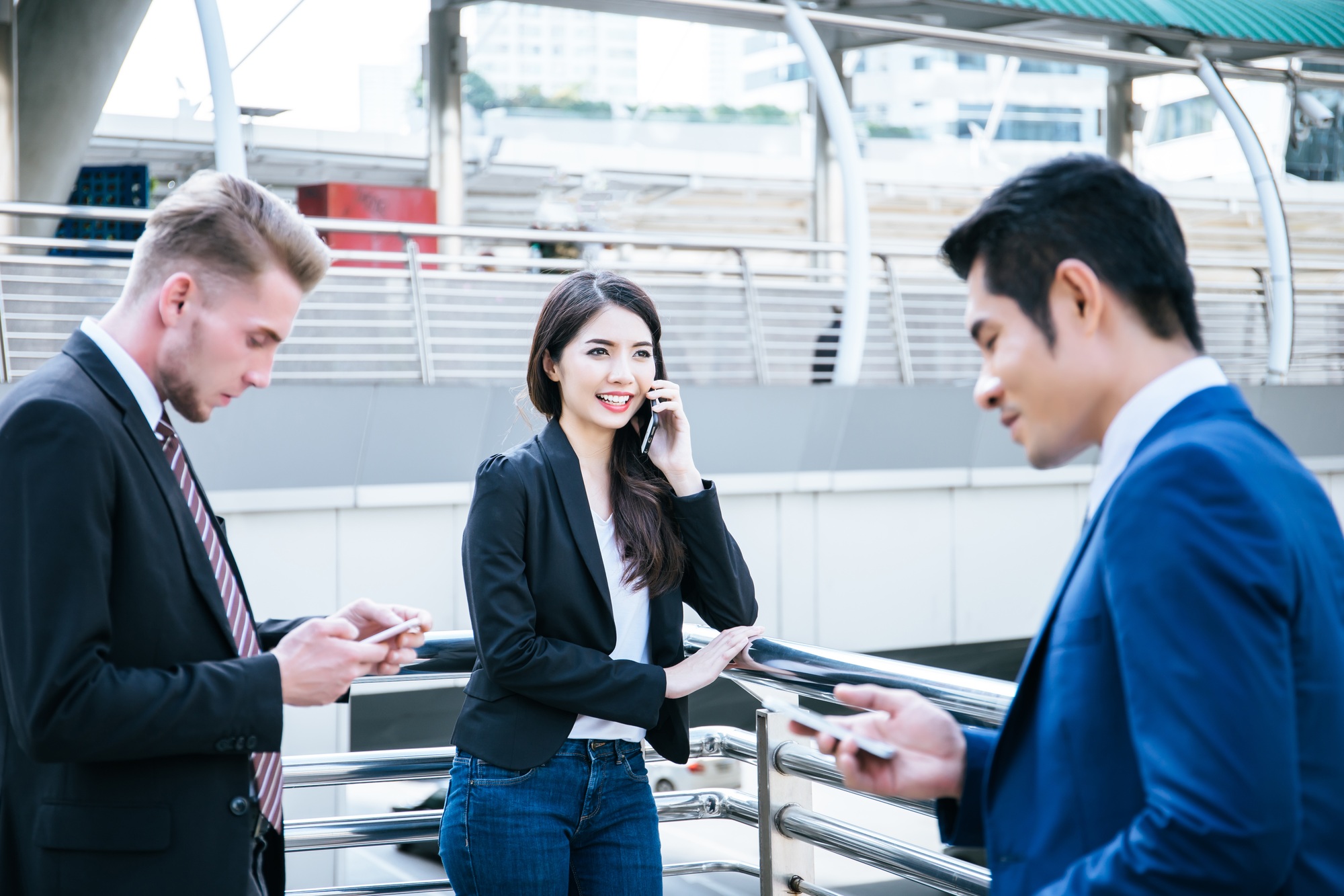 Image of business partners discussing documents and ideas at meeting together outside