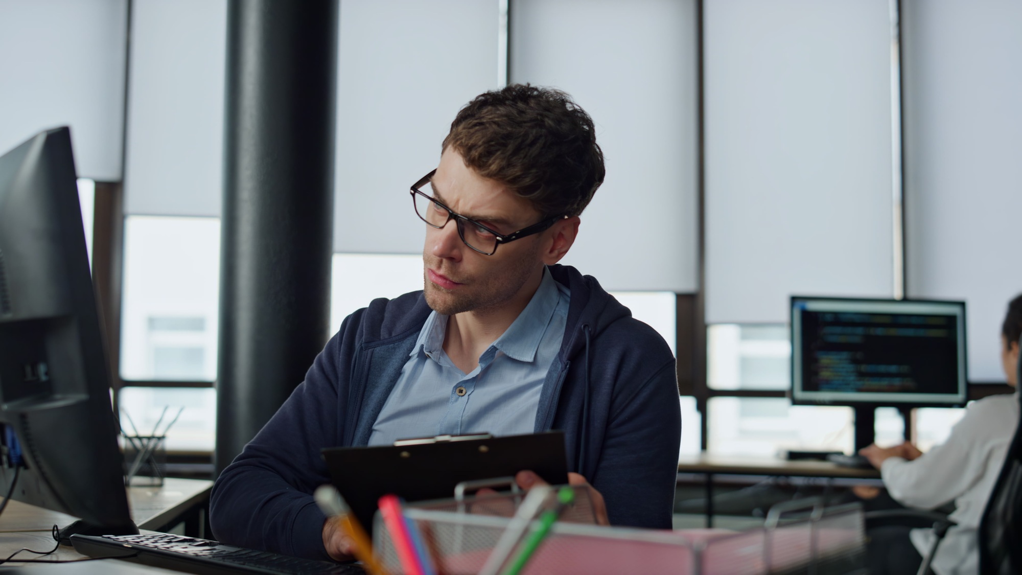 IT manager analysing online report. Thoughtful software engineer making notes