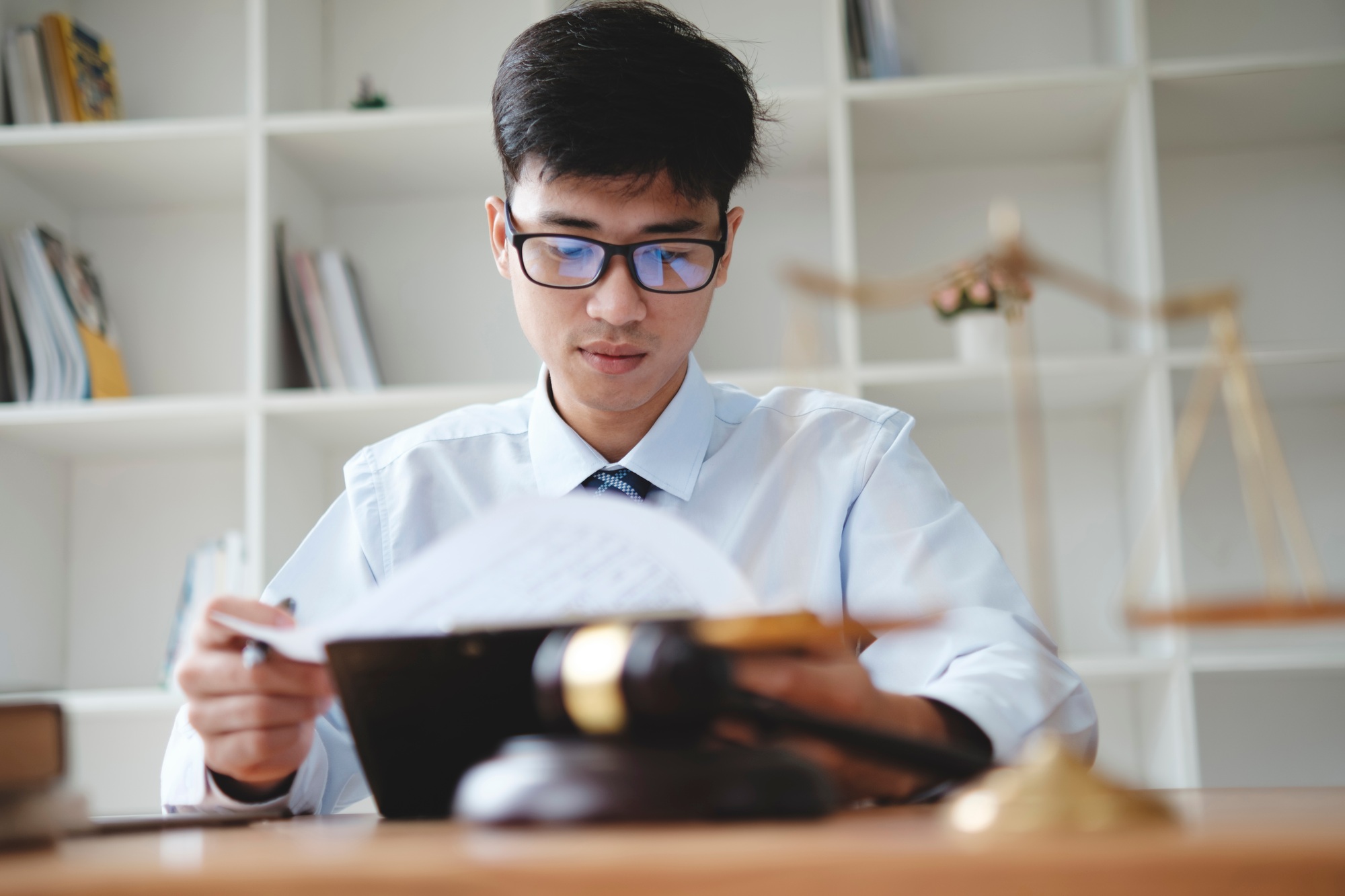 Lawyer Reviewing Legal Documents at Office Desk