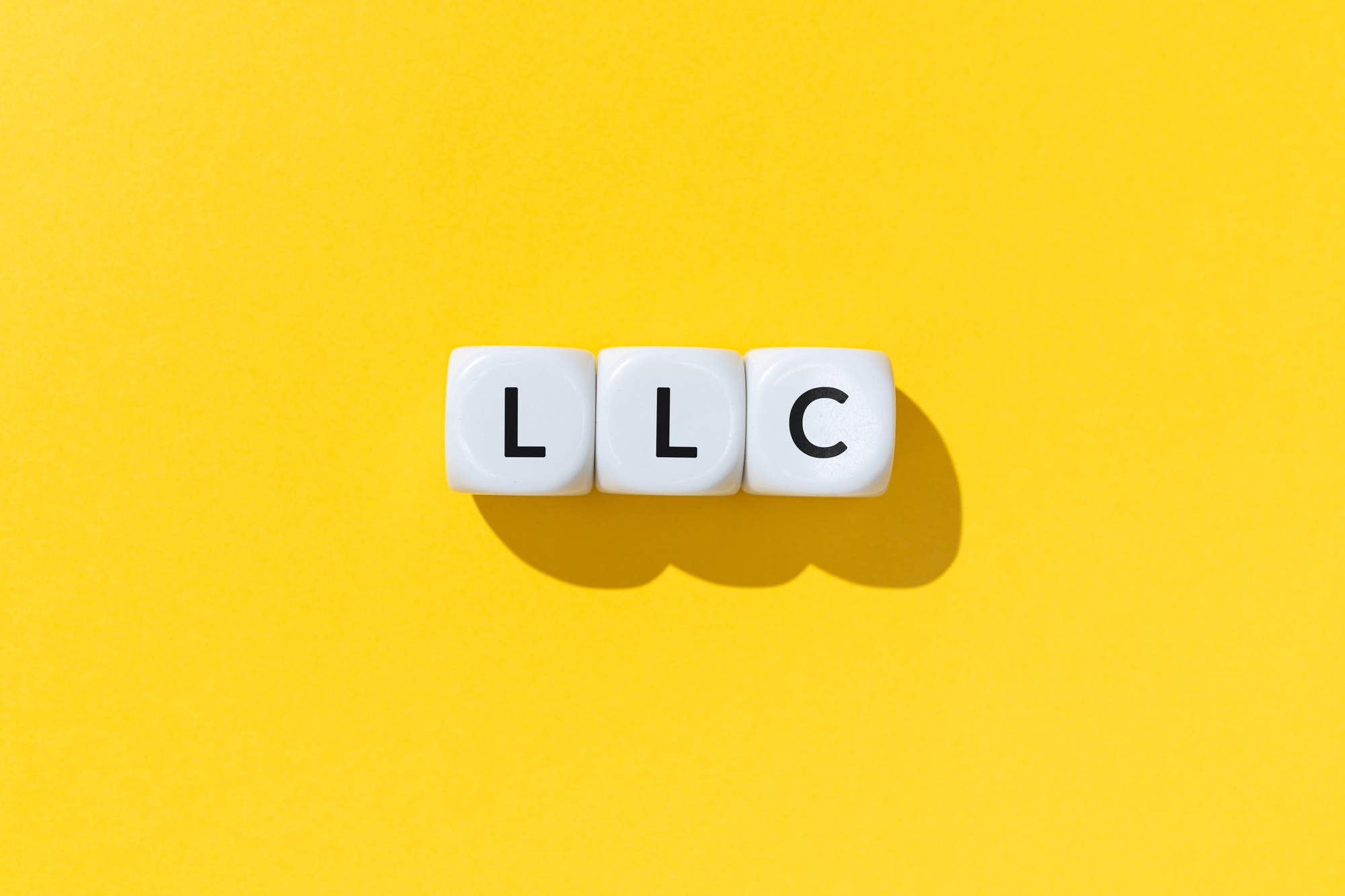 LLC or Limited Liability Company text on white cube blocks