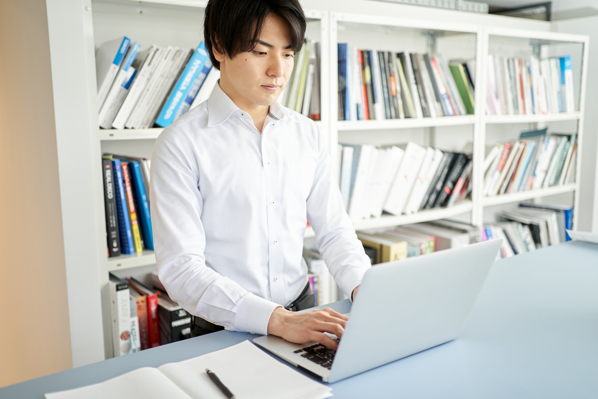 Male construction management engineer who organizes materials on a laptop computer